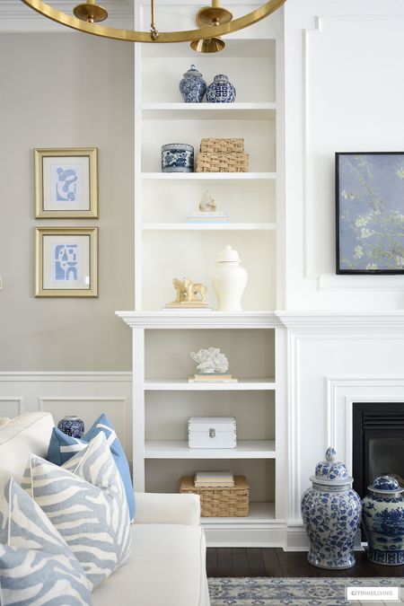 Living room decor with simple, neutral accessories. Bookshelves styled with beautiful ginger jars, baskets, blue and white touches and coastal accents. Home decor, rug, pillows, sofa,

#LTKhome #LTKFind #LTKstyletip