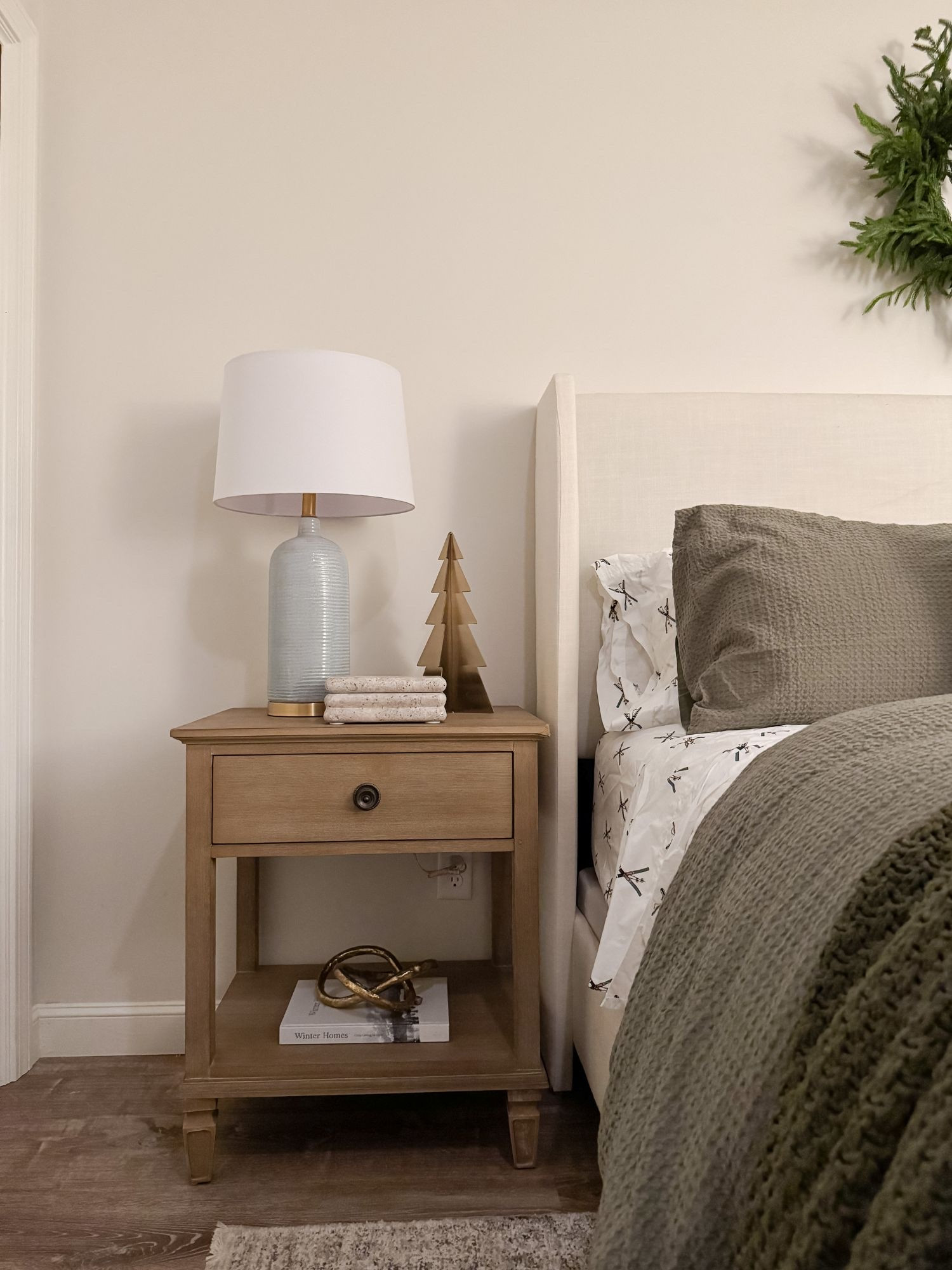 A softly styled winter bedroom nightstand with warm wood, simple holiday accents, and gentle lamplight. This look balances festive charm with calm, everyday coastal warmth. winter bedroom, nightstand styling, coastal bedroom decor, holiday nightstand, neutral bedside decor, cozy lamp styling, wood nightstand, coastal winter decor, minimalist bedroom, serene bedroom, winter home accents, Sherri Calnan Home

#LTKSeasonal #LTKHoliday #LTKHome