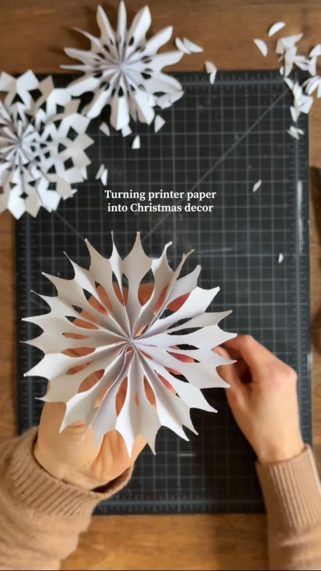 Paper Snowflakes❄️❄️❄️
It’s simple, fun for all ages, and uses what you probably already have at home!
How to:
1️⃣Cut your printer paper into a skinny rectangle.
2️⃣Accordion fold along the short edge.
3️⃣Fold in half to find the center.
4️⃣Cut your design on one half, then trace it to the other side to match.
5️⃣Glue the sides together.

I used fishing line and command hooks to hang mine from the hallway ceiling, along with a few larger lighted snowflakes I found online.

#LTKHome #LTKHoliday #LTKParties
