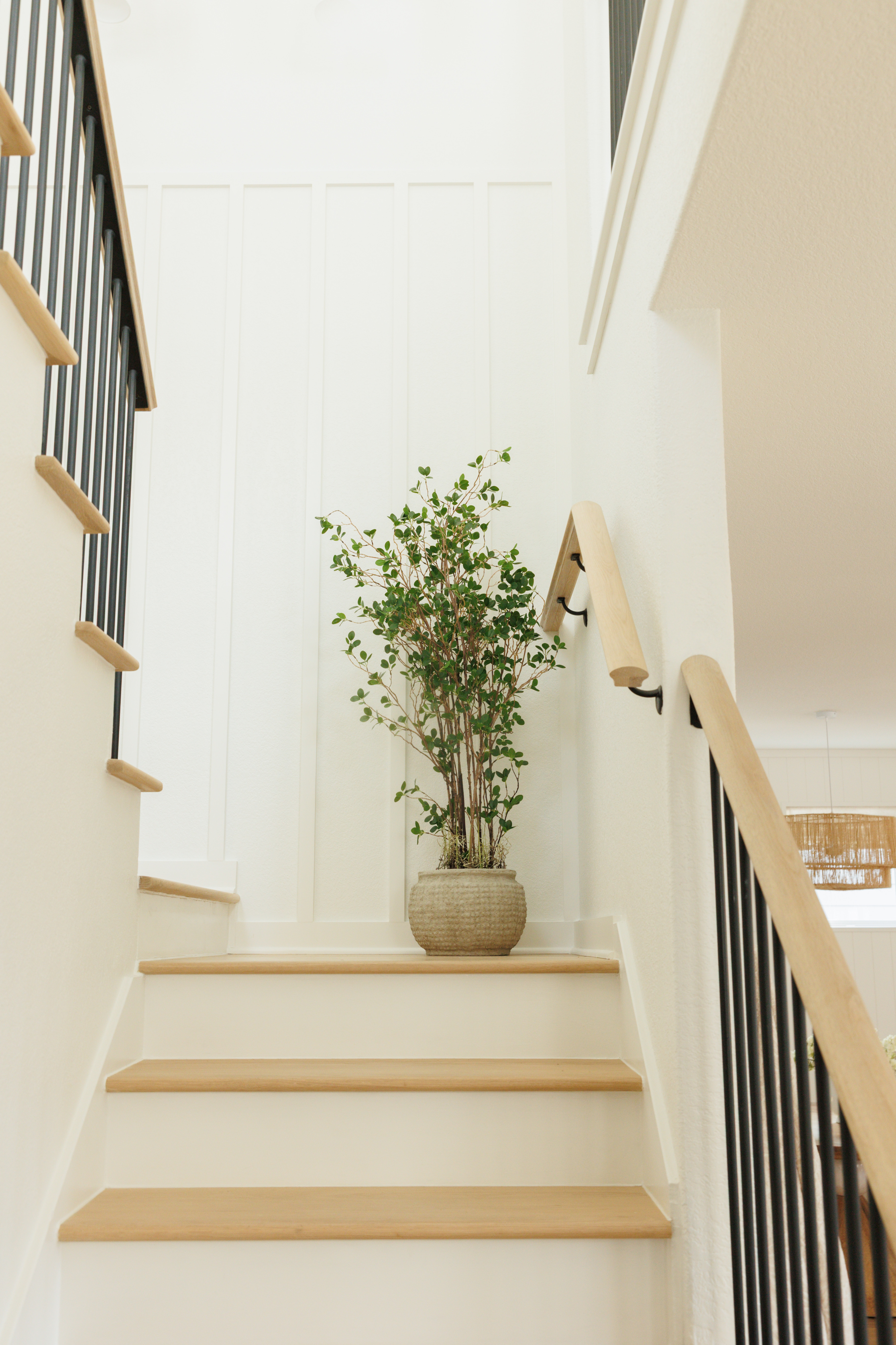 Simple stying for this timeless stairway. One of my favorite affordable faux trees with an oversized pot! View the before on our IG.  

 #LTKHome