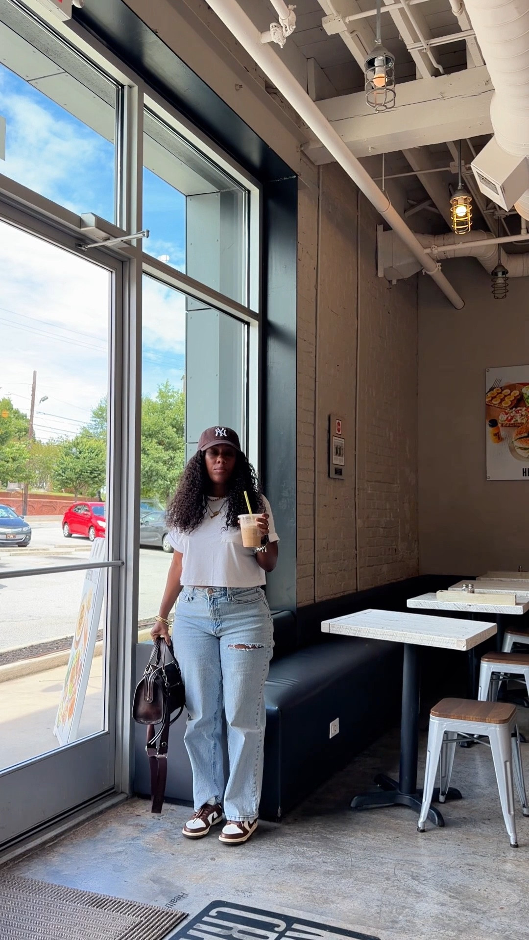 Coffee shop outfit idea. I’m wearing a cropped white pocket shirt, high waisted distressed jeans, brown NY baseball hat, brown faux leather bag, and Nike dunk low cacao wow sneakers

#LTKootd #LTKOver40 #LTKPetite