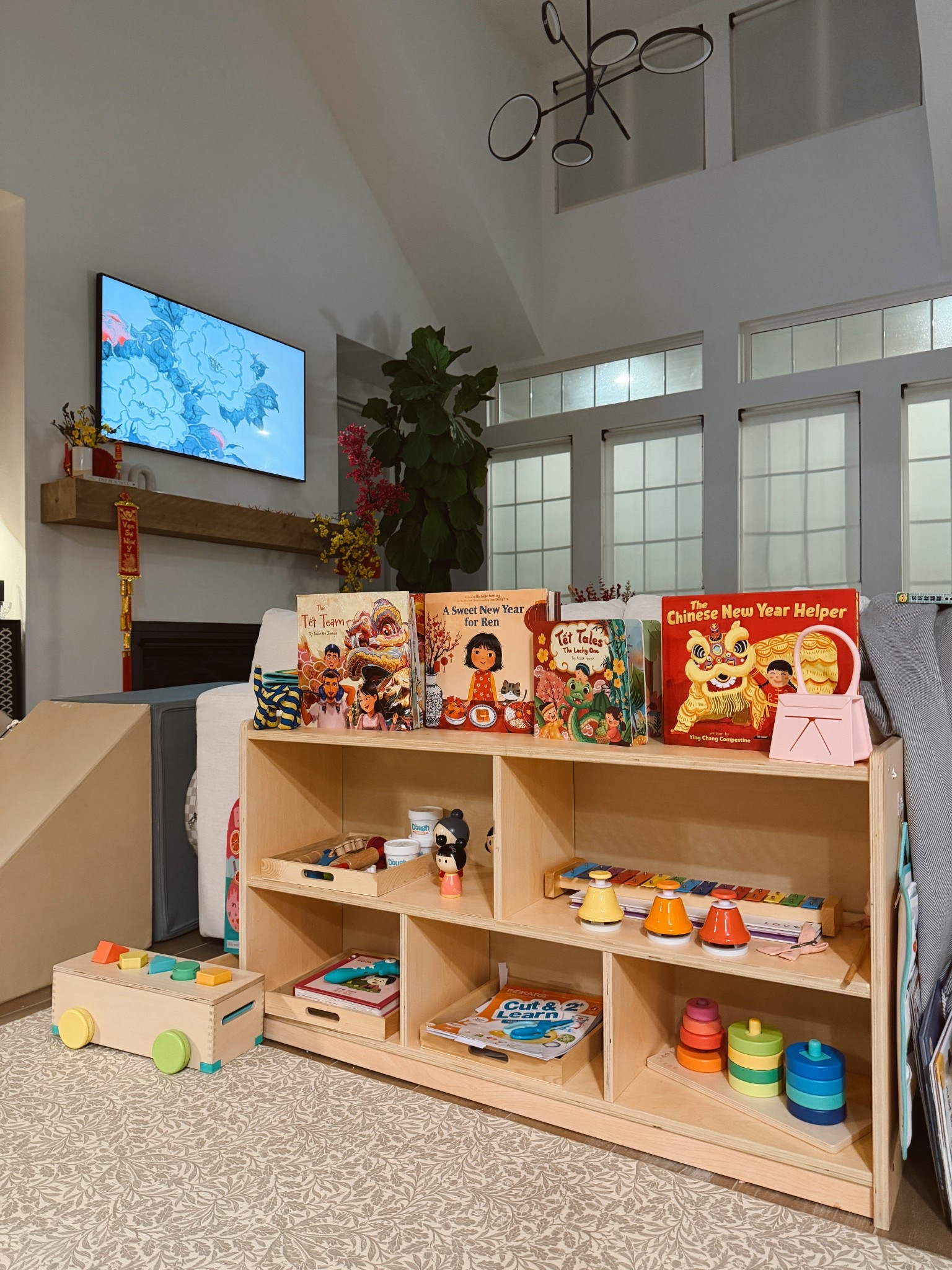 Toddler Montessori toy shelf current rotation for our 2.5 year old daughter. She has her Lunar New Year Books, Lovevery block set, Lovevery music set, a cutting activity and toddler-friendly scissors, play dough set and more. 

#LTKKids #LTKmomlife