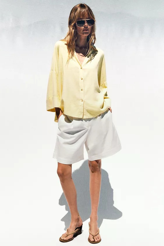 Lapel collar shirt with V-neck and wide sleeves below the elbow finished with a turn-up. Front bu... | Zara US