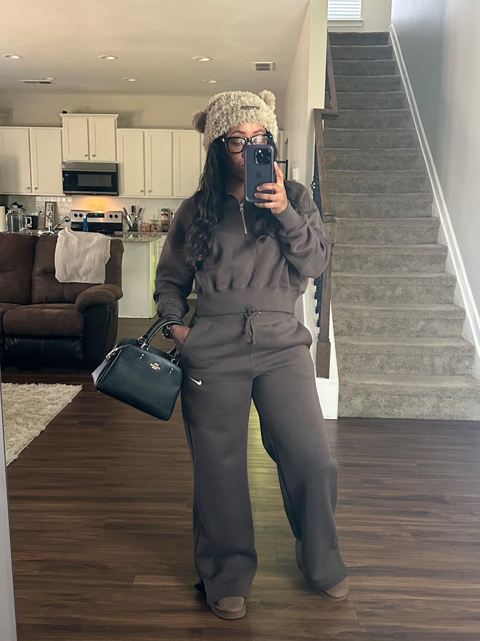 Chill day outfit. Nike Phoenix fleece sweatpants and matching quarter zip pullover. I styled this outfit with a black coach purse, brown bucket hat, and brown bear paw boots

#LTKFindsUnder100 #LTKFindsUnder50 #LTKootd