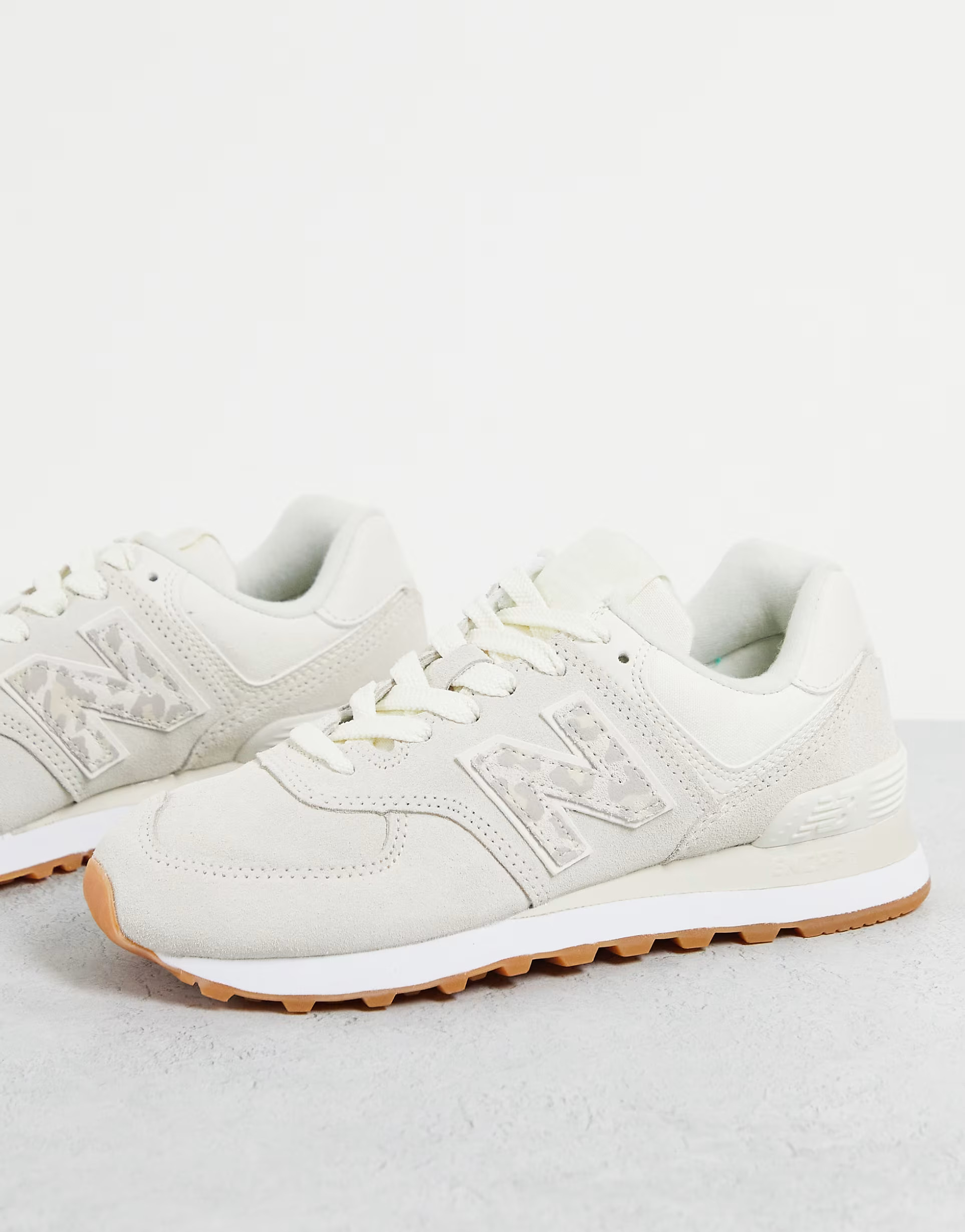 New Balance 574 sneakers in white and animal print | ASOS (Global)