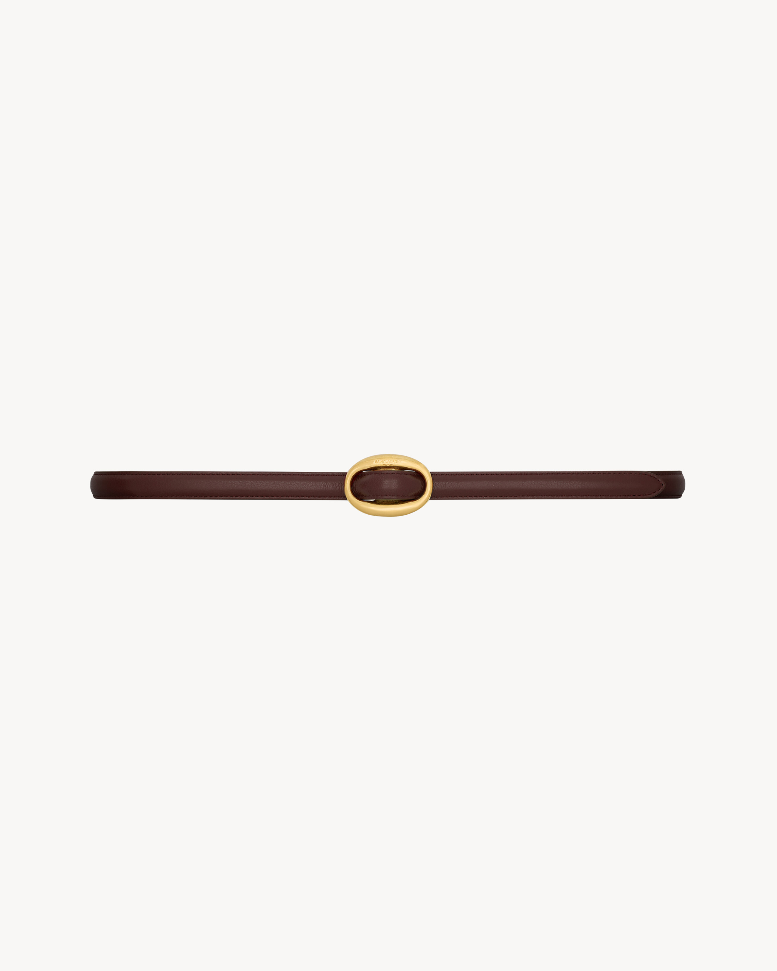 thin reversible belt featuring an oval buckle engraved with the SAINT LAURENT PARIS signature. | Saint Laurent Inc. (Global)