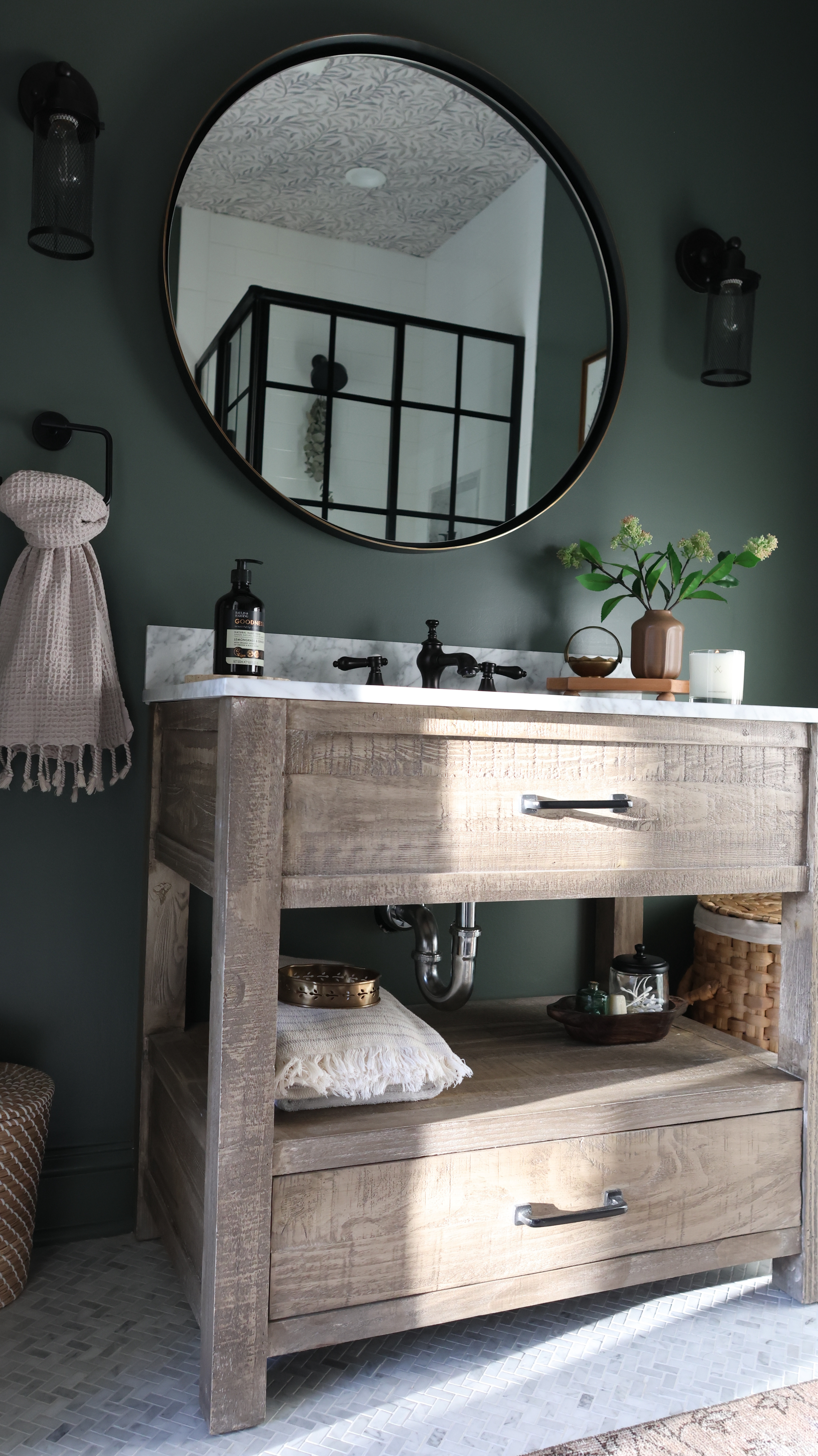 Part two of my No Demo Reno is here! 🛠✨ This bathroom transformation leans into vintage charm and rustic character — think warm wood tones, texture, and collected details that tell a story. 🪵🕰️

The moody green adds just the right amount of drama without overpowering the space, and the wallpaper brings visual interest that draws your eye up and makes the room feel taller. Add a few vintage pieces, mix
metal finishes, and these little details make a big difference!

And let’s talk function: the sliding shower doors are not only stylish but so convenient for washing the dogs—no lifting needed! 🐶🚿 This was a huge consideration for me since I have multiple chronic spine diseases and need to design spaces that support that. 

#LTKHome