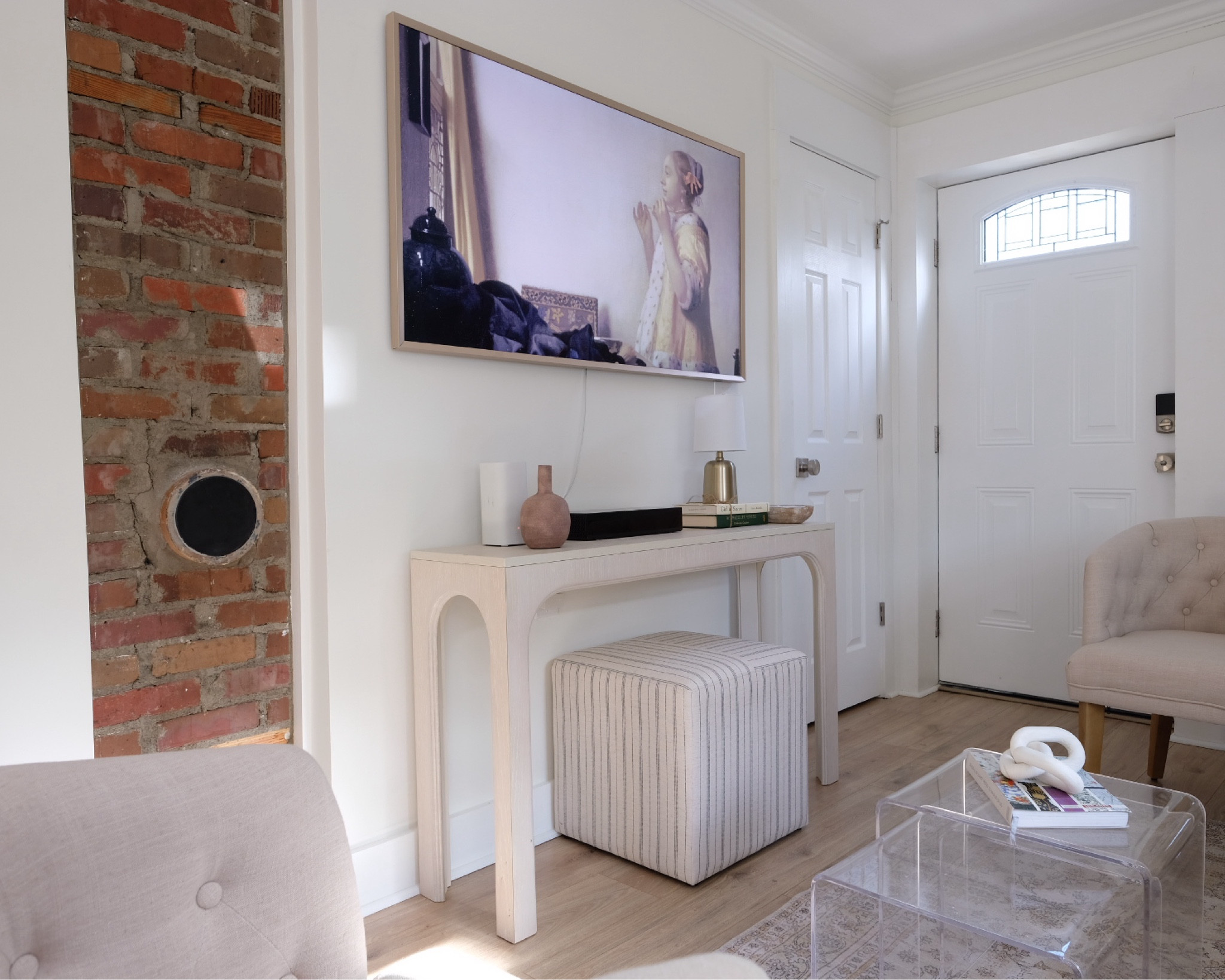 French cottage, coquette decor, coquette style, narrow console, upholstered stool, upholstered ottoman, lg frame tv, brick wall, acrylic coffee table, small loving room, wood lvt, 

#LTKhome #LTKSeasonal #LTKSpringSale