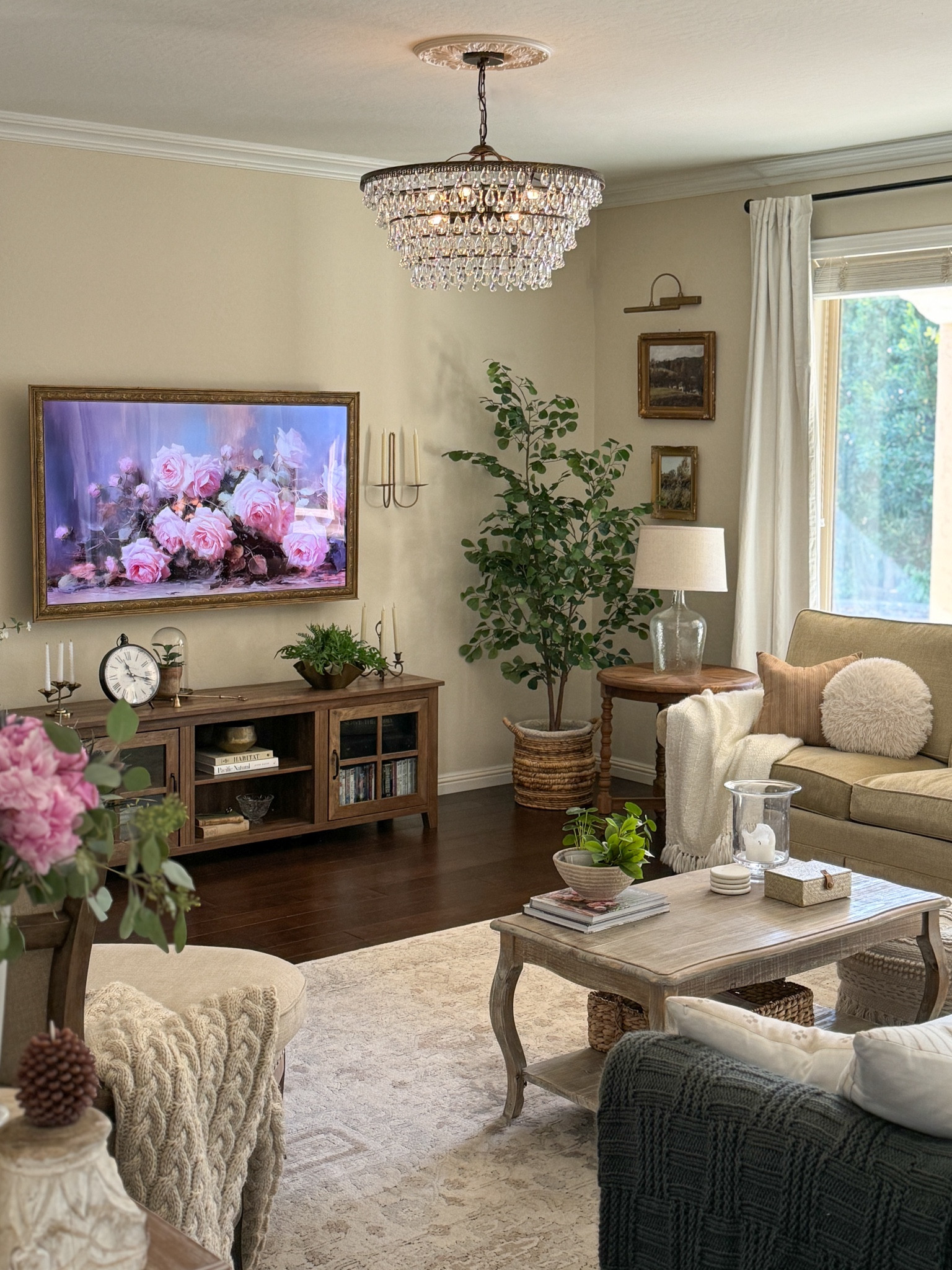 Neutral living room with French country and European touches. 

I used European Gold Rub n Buff on the art light and wall candle sconces 

Crystal chandelier, ceiling medallion, coffee table, tv console, tv cabinet, linen curtains, faux tree, faux plants, neutral rug

#LTKSeasonal #LTKhome