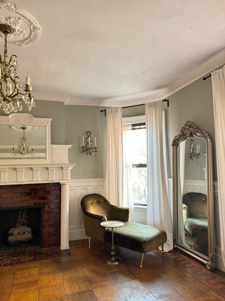 Under process dining room 

Olive green velvet chaise lounge, silver floor mirror, crystal wall sconce, crystal chandelier, ceiling medallion, crown molding, linen curtains, sheer curtains 

#LTKhome