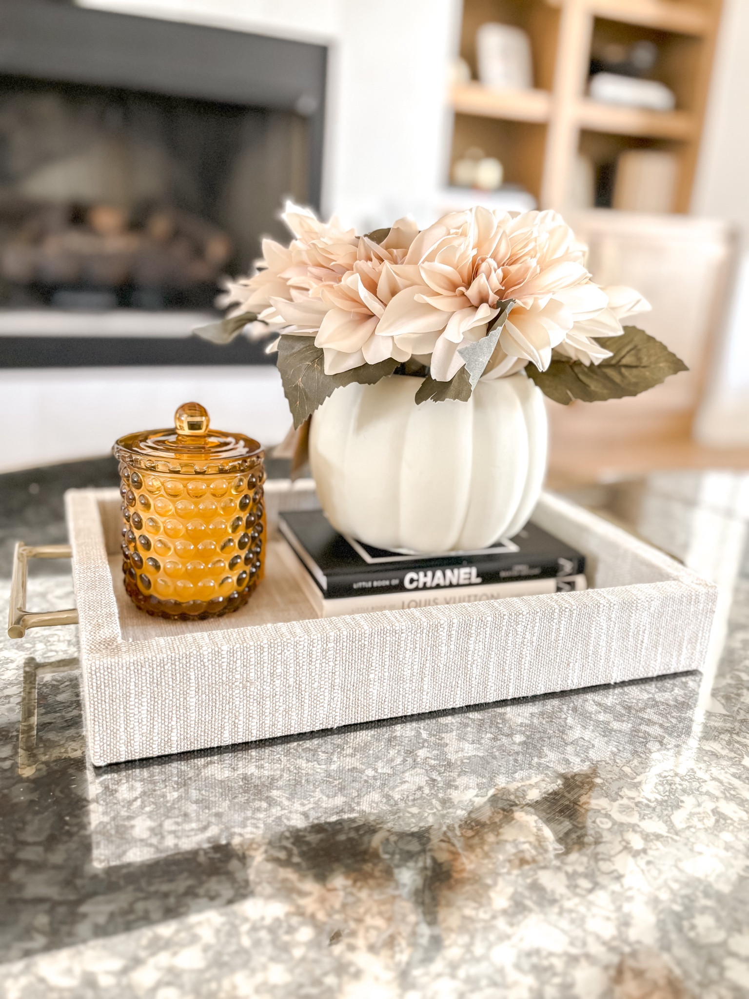 Pumpkin planters are the cutest way to add some subtle fall decor to your home! This linen tray is a staple in my living room and these little designer books fit perfectly for a mini book stack! I’m always burning a candle and this House of Harlow bubble candle adds a great pop of color to an otherwise neutral display.

#LTKSeasonal #LTKHome #LTKHalloween