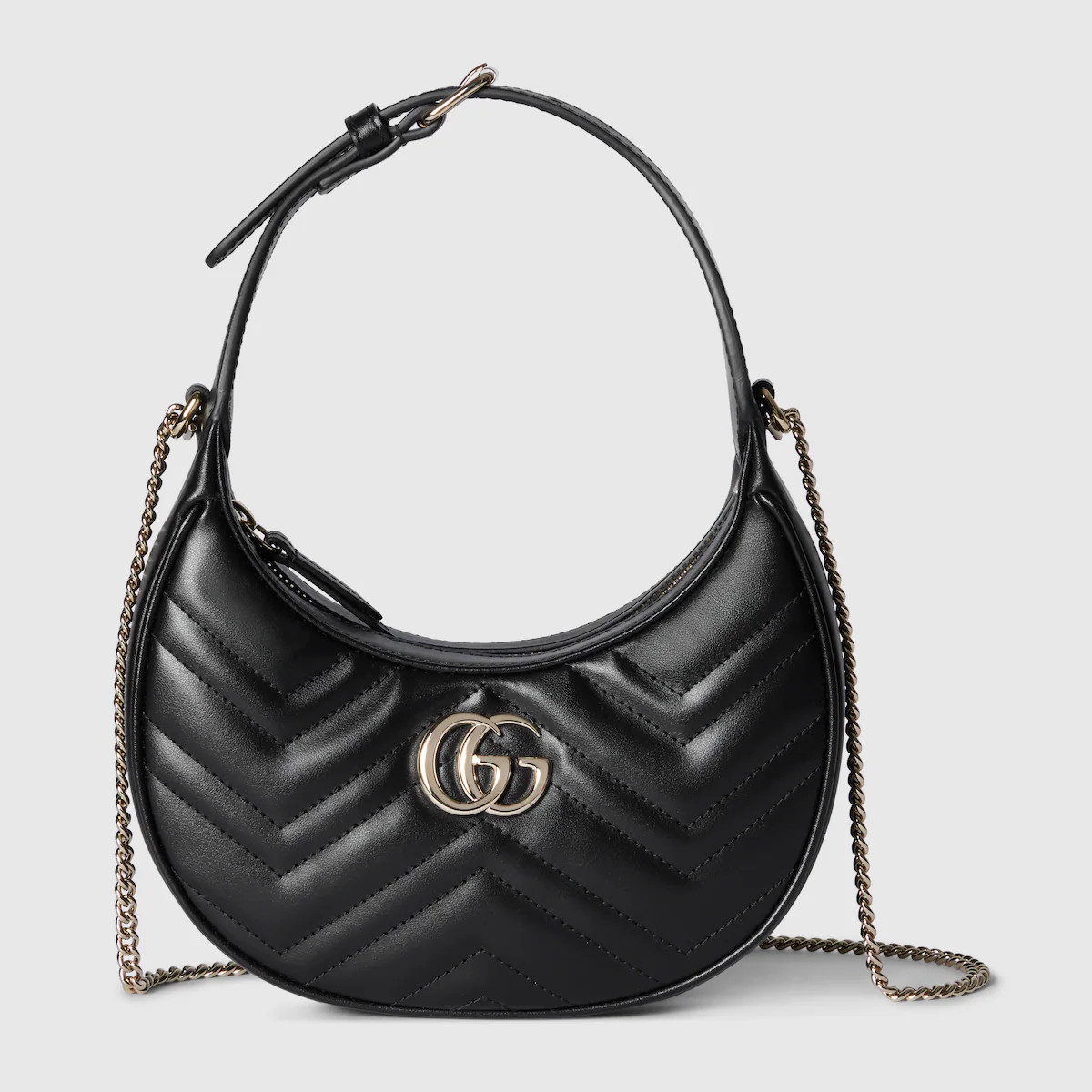 With a crescent silhouette and textured black leather, this shoulder bag has a defined retro feel... | Gucci (US)