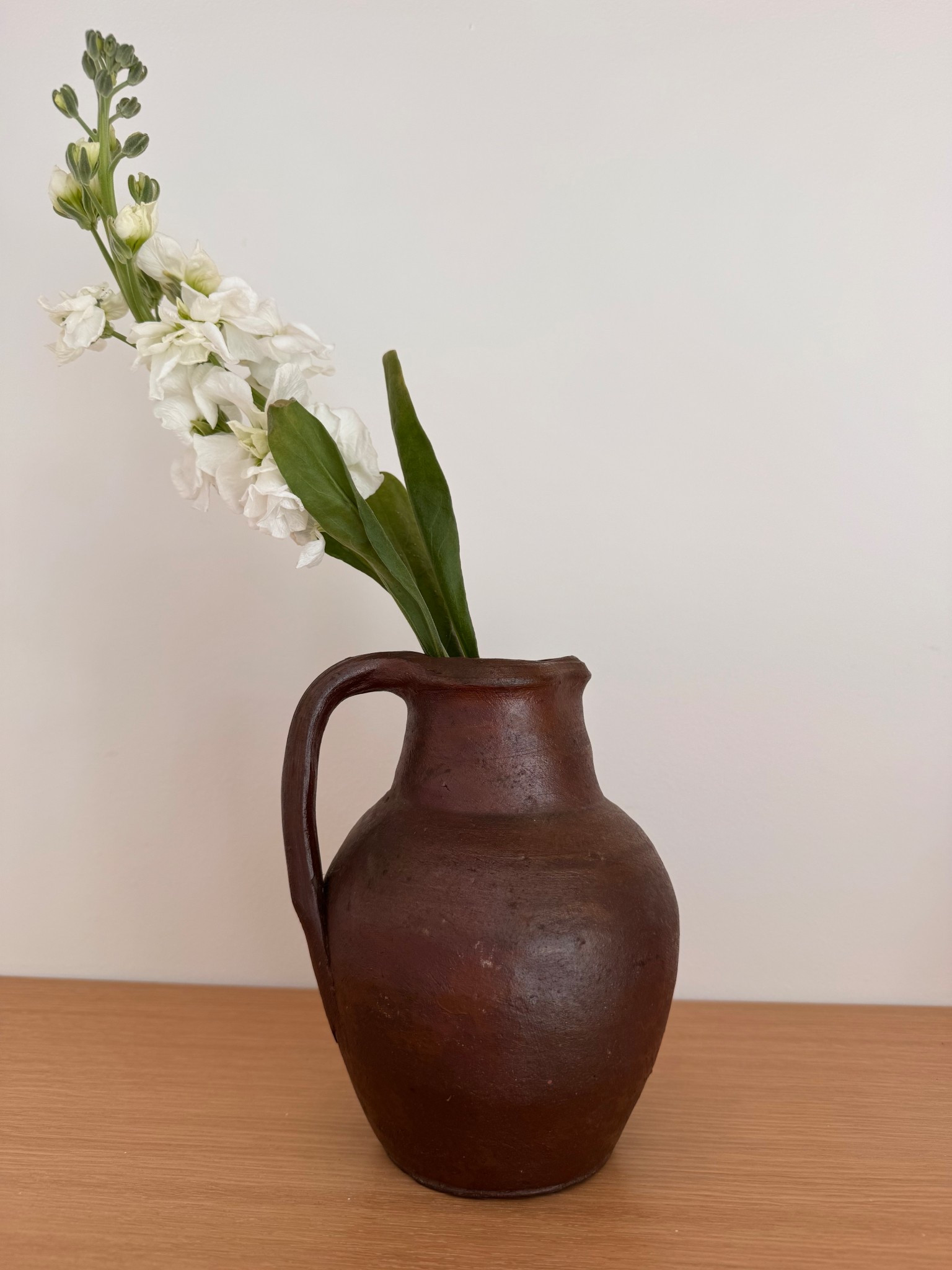 An antique French cruche from the Gers region, sourced in France.
The rich brown earthenware and sculptural form make it perfect for a single stem or shelf styling. Pieces like this were once used in farmhouse kitchens for water or wine — today they bring so much warmth and history to a space.

#collectedhome #frenchpottery #quietluxuryhome #europeanfarmhouse #vintagevessel

#LTKHome #LTKSpringSale