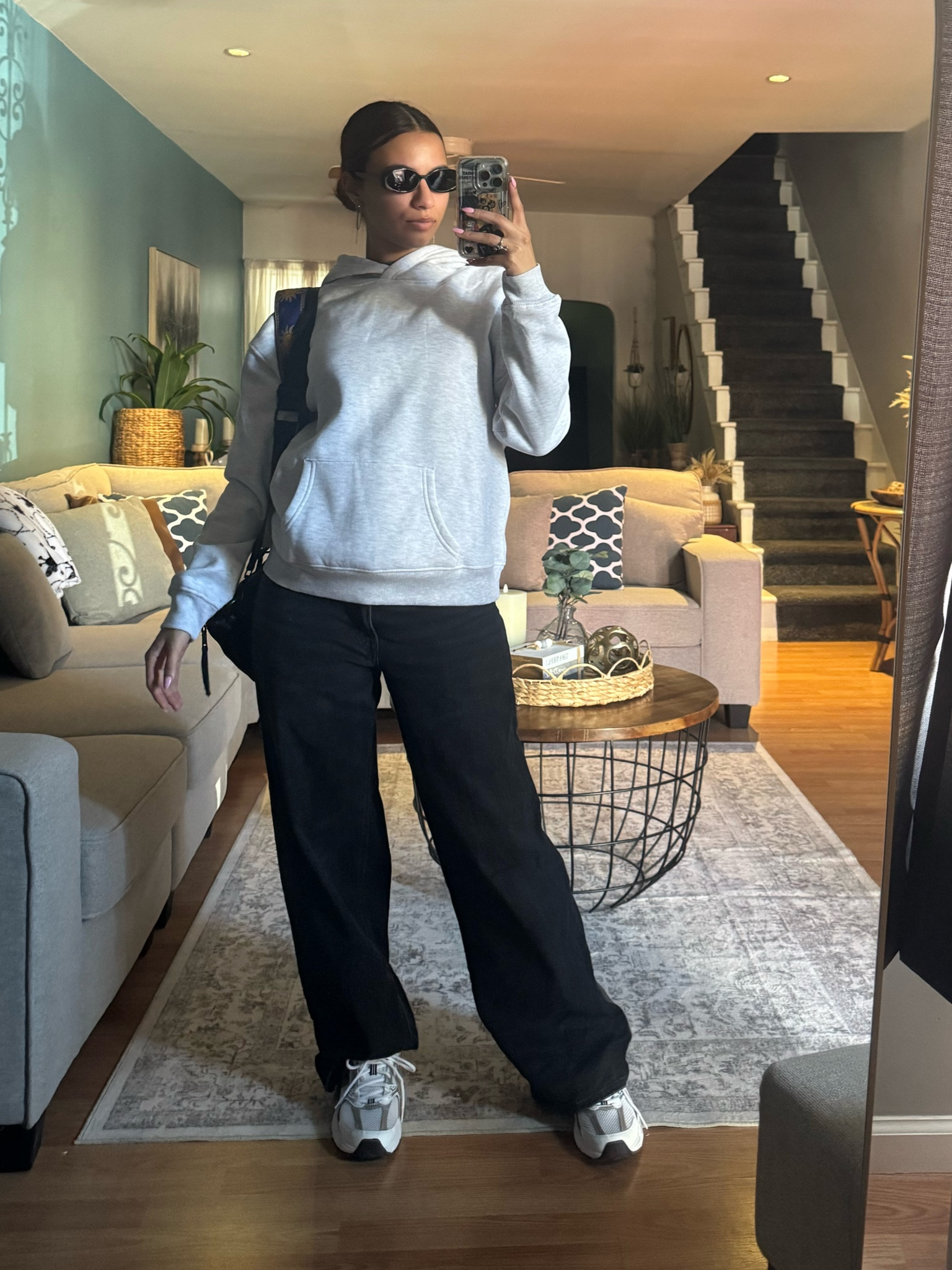 Grey hoodie, oversized hoodie, black jeans, wide bottom jeans, new balance sneakers, new balance 530, round sun glasses, black sun glasses, silver jewelry, silver earrings 

#LTKShoeCrush #LTKStyleTip #LTKFindsUnder100