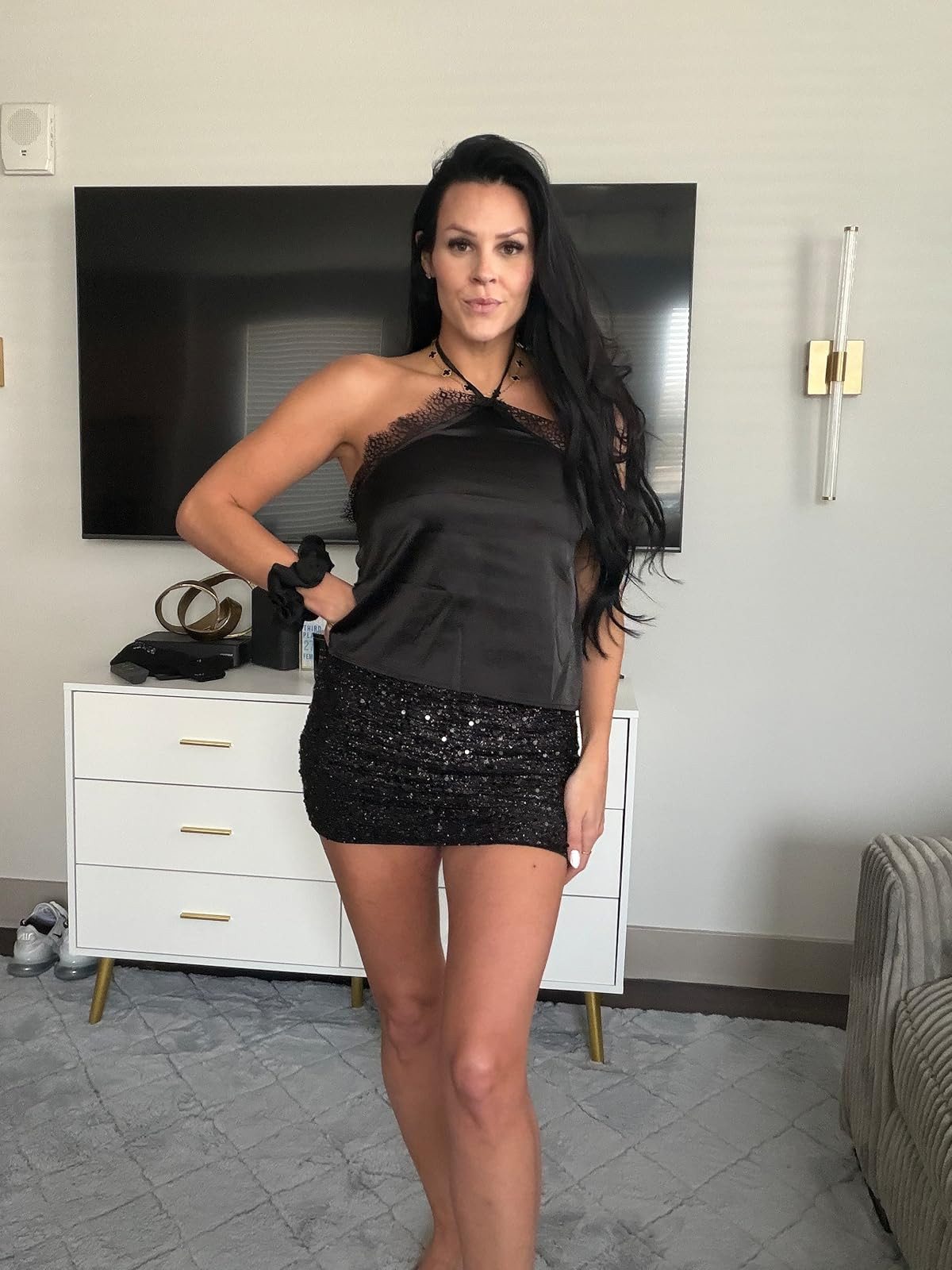 Glitzy and glam. This black satin halter top with delicate lace trim paired with a shimmering sequin mini skirt is the ultimate high-shine look for your next night out. #NightOutLook #SequinSkirt #LTKstyletip 

 #LTKdayinmylife #LTKgrwm #LTKootd