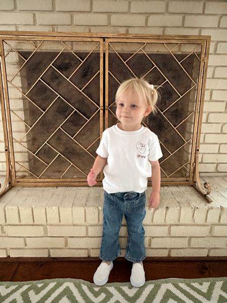 We sized down in the toddler jeans. Emma is 2 and is wearing the 18 mo size. Embroidered t shirt size 2T 