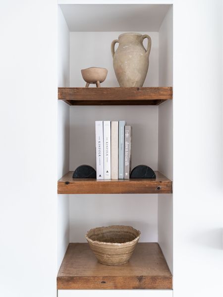 Living room shelves styled with vases, bowls, and books.

Home decor, terracotta vase, footed bowl, home interior books, marble book ends, decorative bowl. 

#LTKhome #LTKunder50