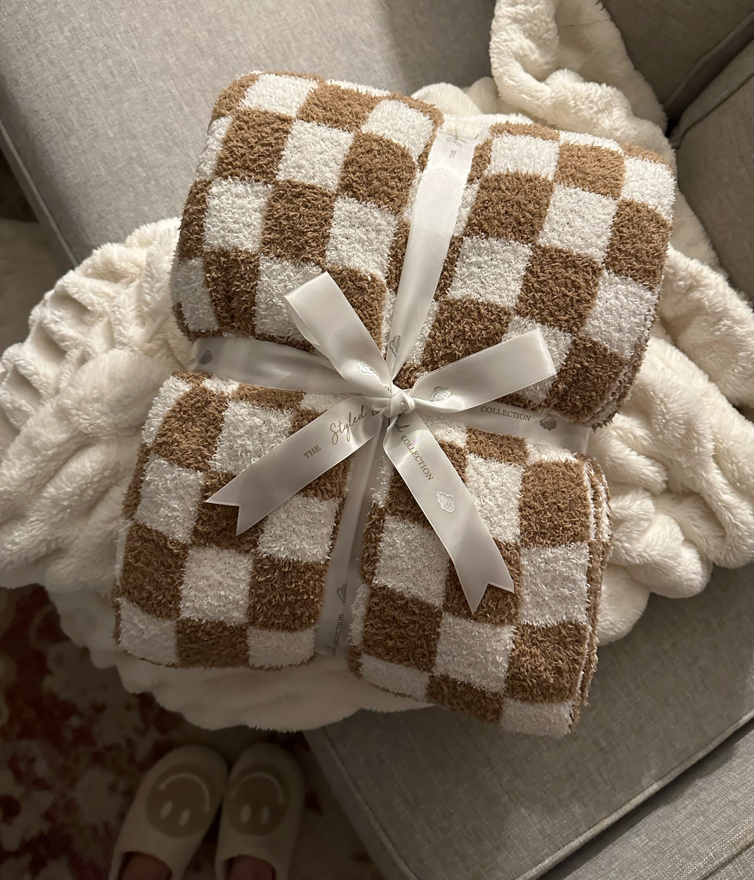 Checkered blanket on major sale for $45! My Christmas gift from my mama 🎁🤍 seriously so soft and I prefer over barefoot dreams! 

Cozy blanket, sale alert, home decor, checkered trend, brown and white, the styled collection 

#LTKsalealert #LTKunder50