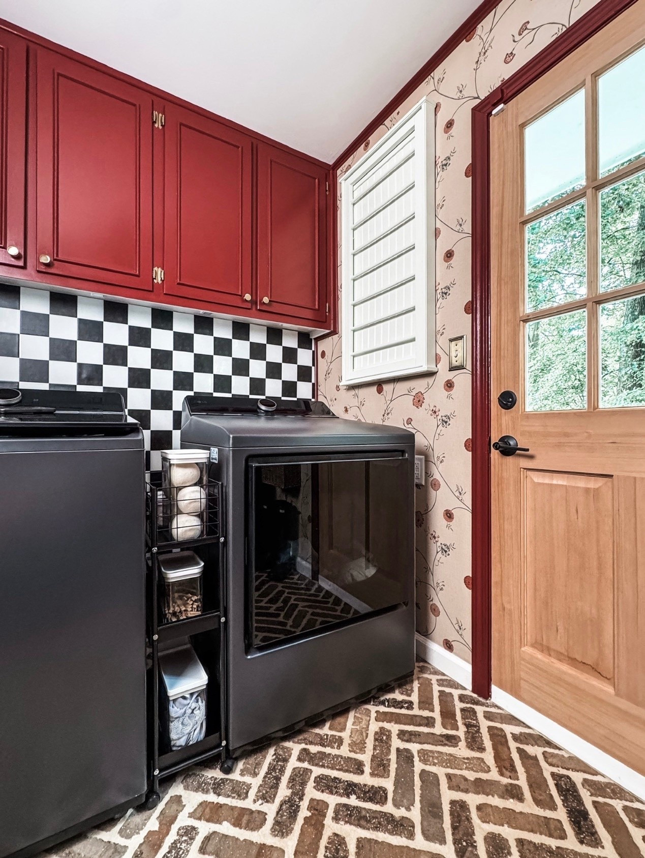 A laundry room that proves functional can still be beautiful 🧺❤️ Deep red shaker cabinets, a black washer and dryer, and classic black-and-white checkerboard tile create a bold, timeless look. Layered with vintage-inspired floral wallpaper, brick herringbone floor tile, and smart laundry storage organizers, this space blends traditional design with everyday practicality. Finished with a wood door, plantation shutters, and thoughtful details that make laundry day feel a little more elevated.

#eanesinteriors #laundryroomdesign #laundryroominspo #redcabinets #shakercabinets #checkerboardtile #blackwasher #blackdryer #vintageinspired #traditionalinteriors #brickfloor #herringbonetile #homeorganization #ltkhome

#LTKHome #LTKSeasonal #LTKOver40