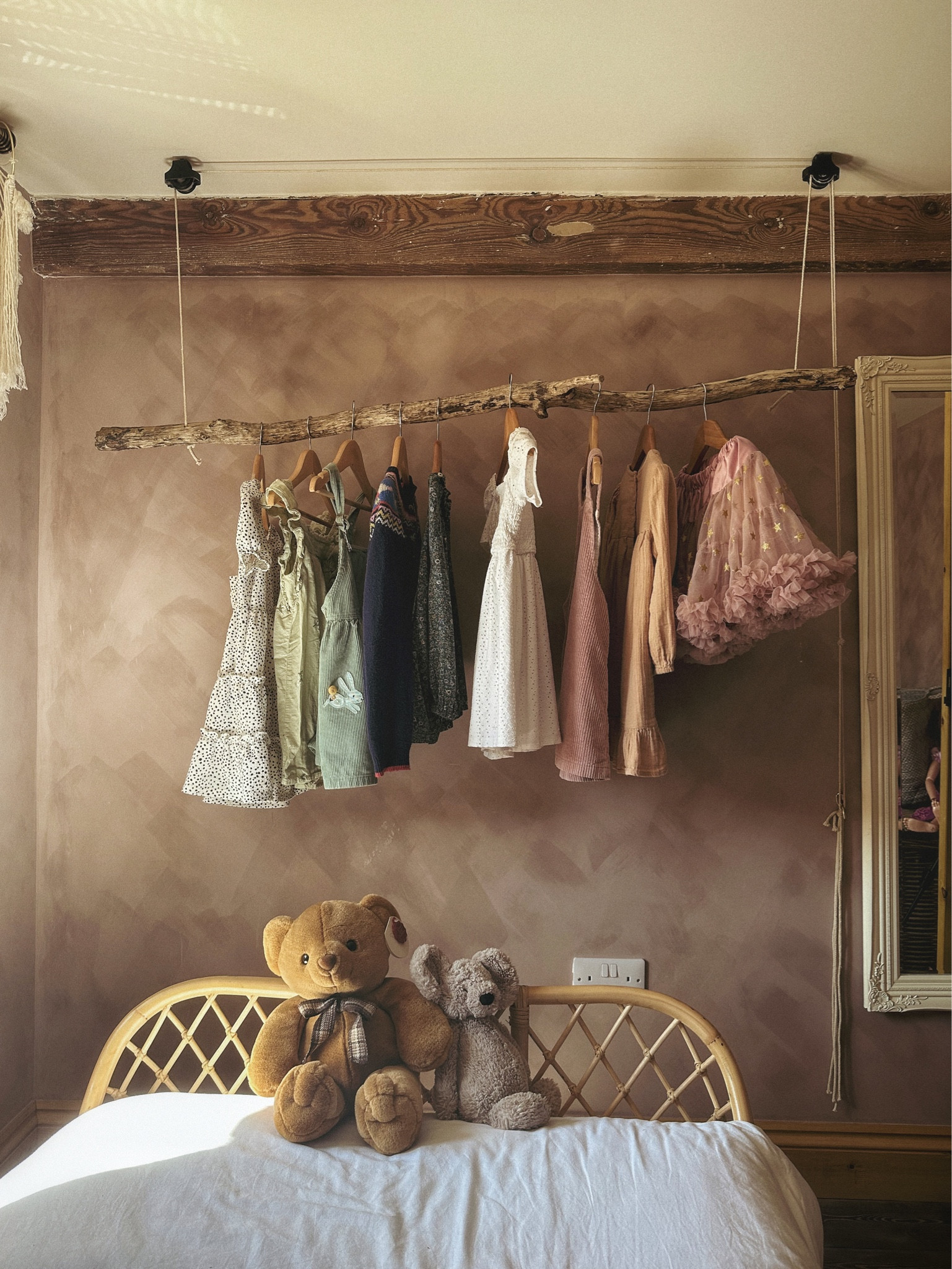 Rustic pulley clothes rail designed to save space, surrounded by a rattan bed frame design and long mirror to enhance the feeling of space in the room.

#LTKhome #LTKover40 #LTKstyletip