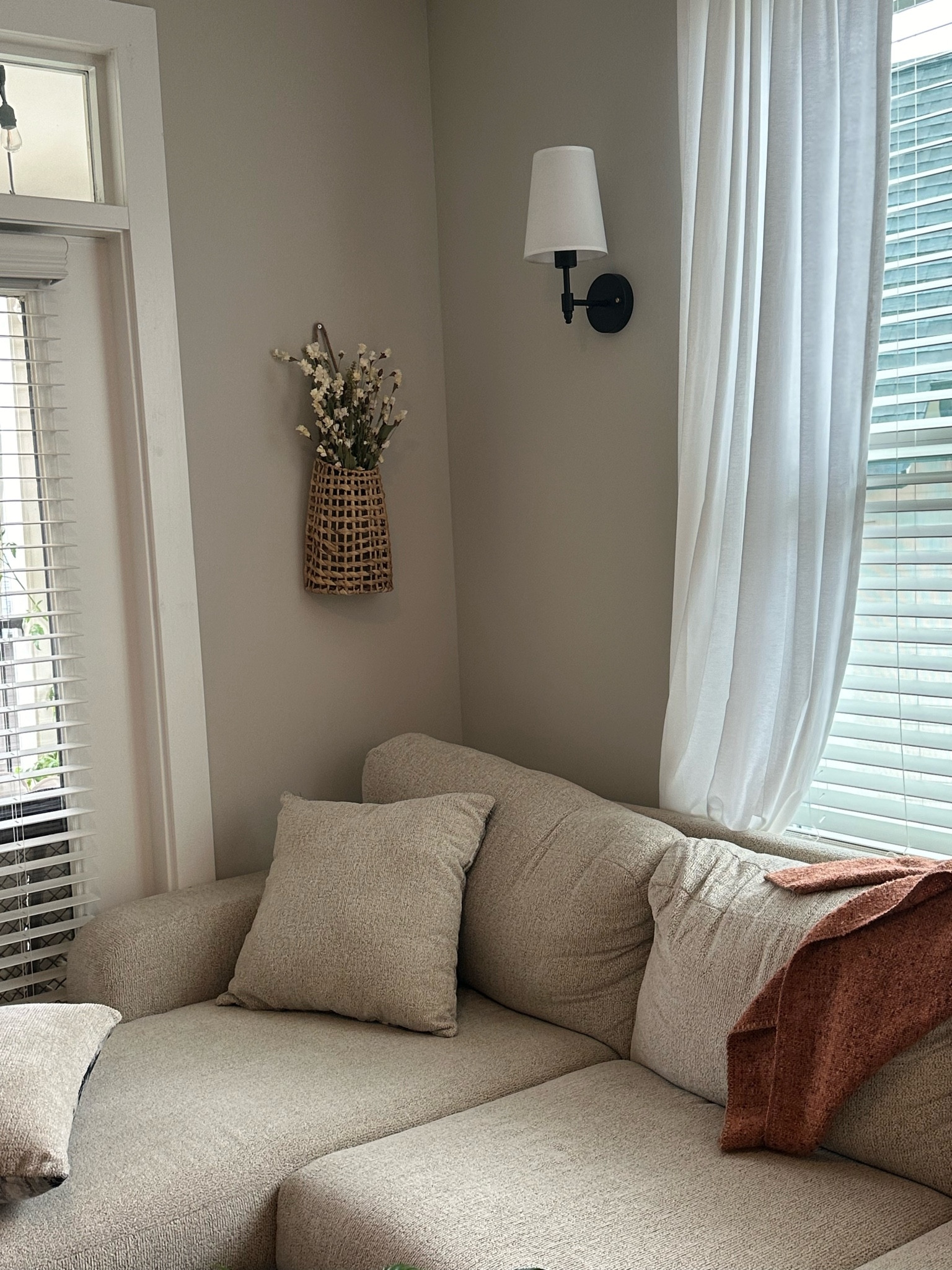 love this cozy corner of our apartment!!! sconces and wall basket from amazon,  faux florals from hobby lobby, couch from rooms to go, blanket from target 🫶🏼 i have different options linked as well!!

#LTKHome