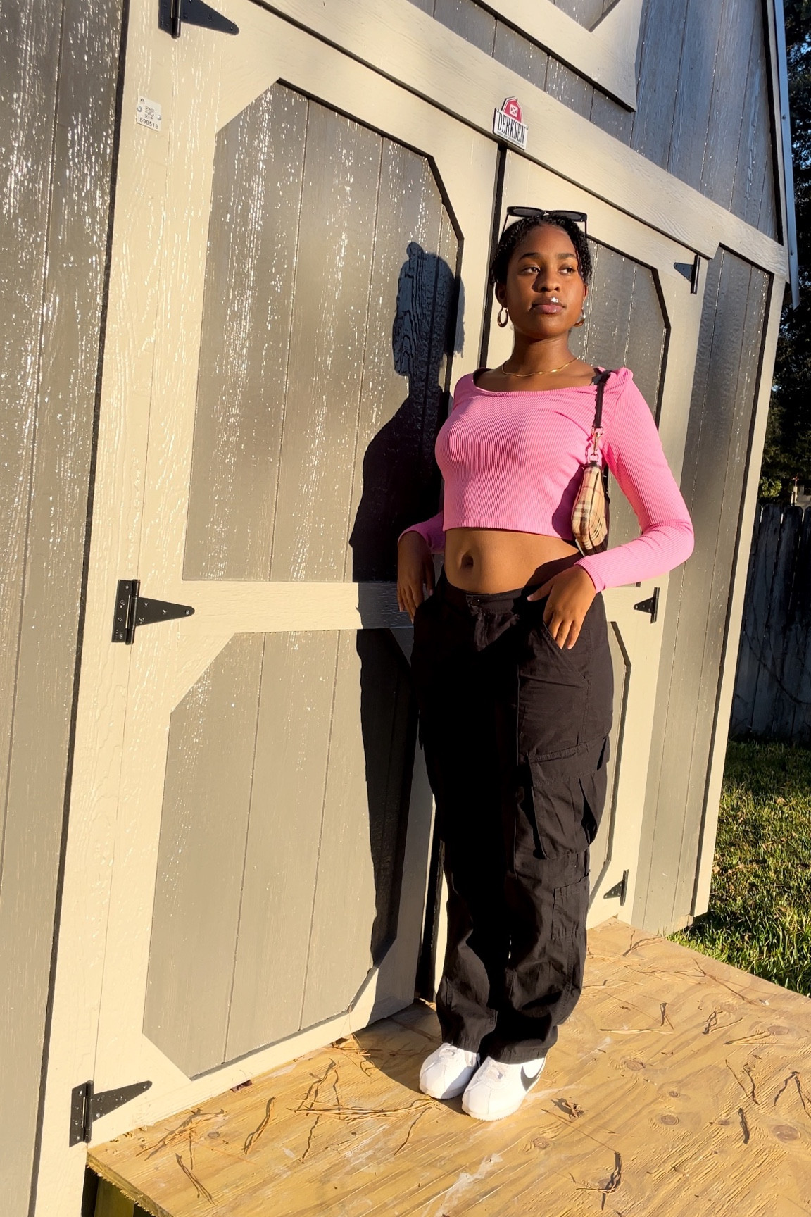 pink long sleeve ribbed crop top, black cargo pants, white nike cortez

#LTKstyletip #LTKunder50