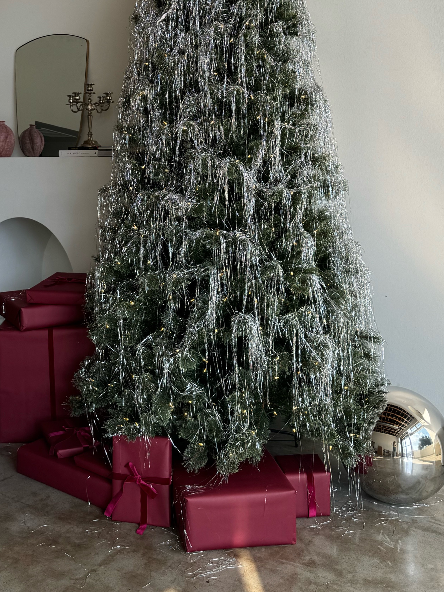 Christmas decor: matte burgundy wrapping paper, metallic silver large balls, tinsel, Christmas tree 

#LTKHoliday #LTKHome #LTKParties