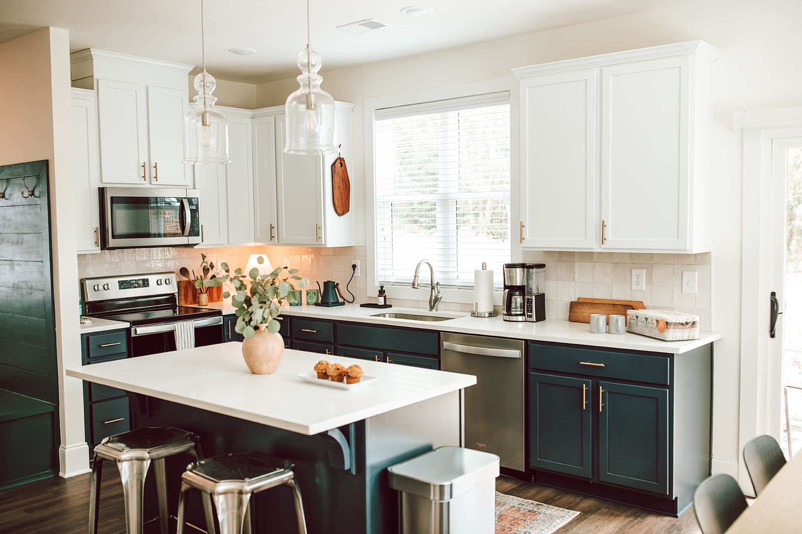 Light and bright kitchen with navy blue lower cabinets. Perfect Airbnb kitchen.  

 #LTKHome