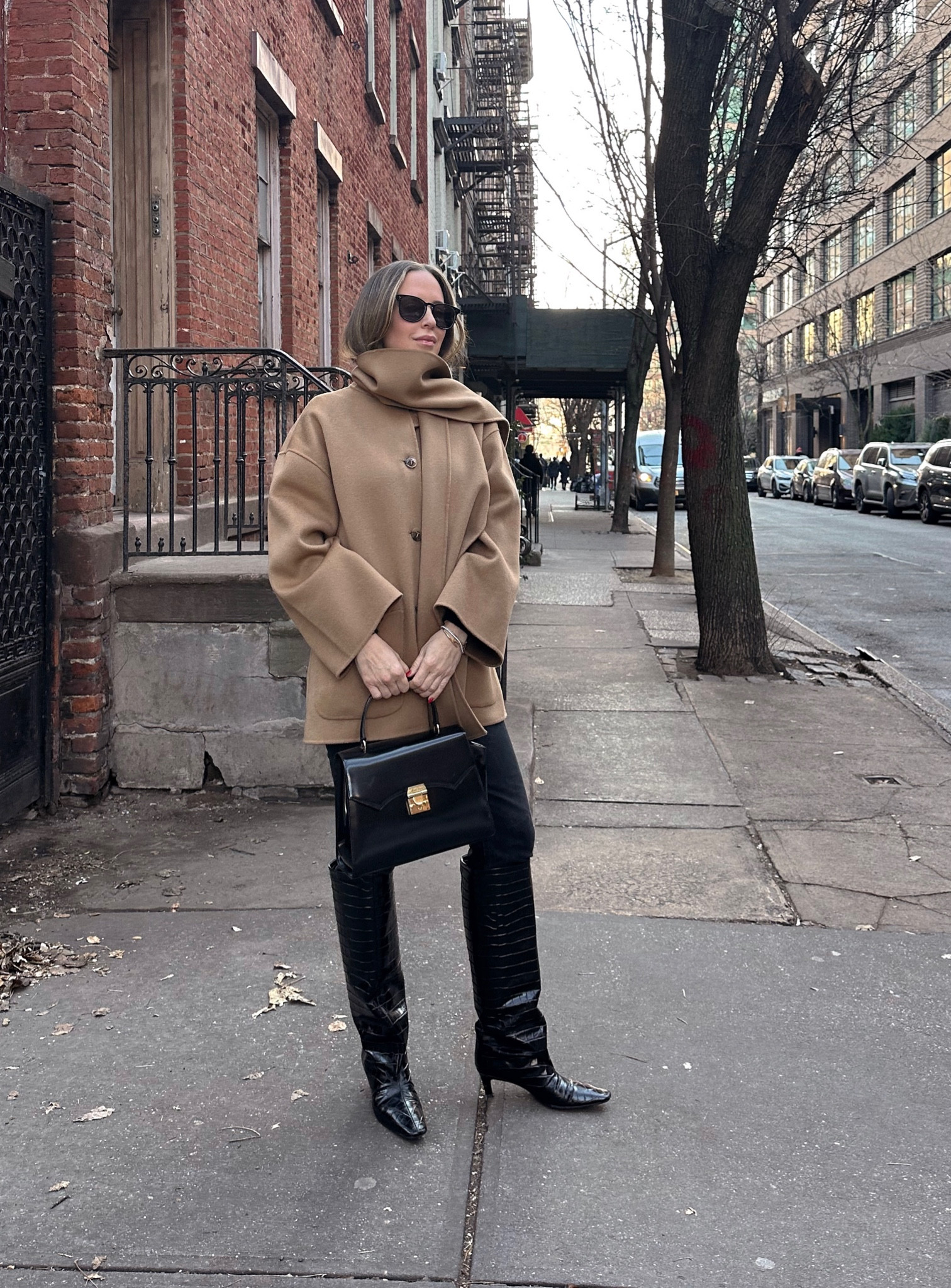 I am wearing a size 34 in the toteme coat. Boots also run TTS.