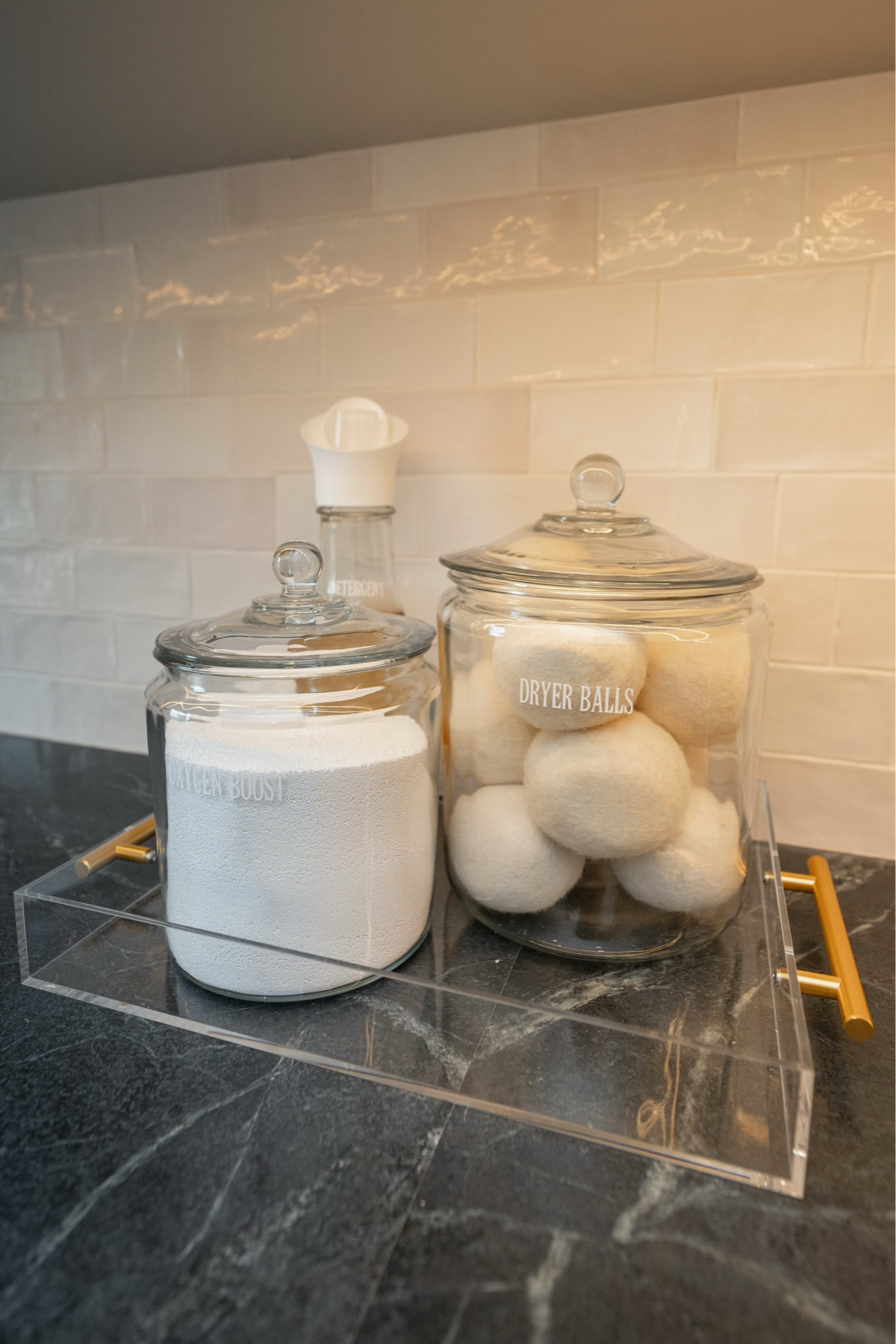 An organized laundry space with beautiful glass jars makes laundry day a joy. #laundrygoals

#LTKHome