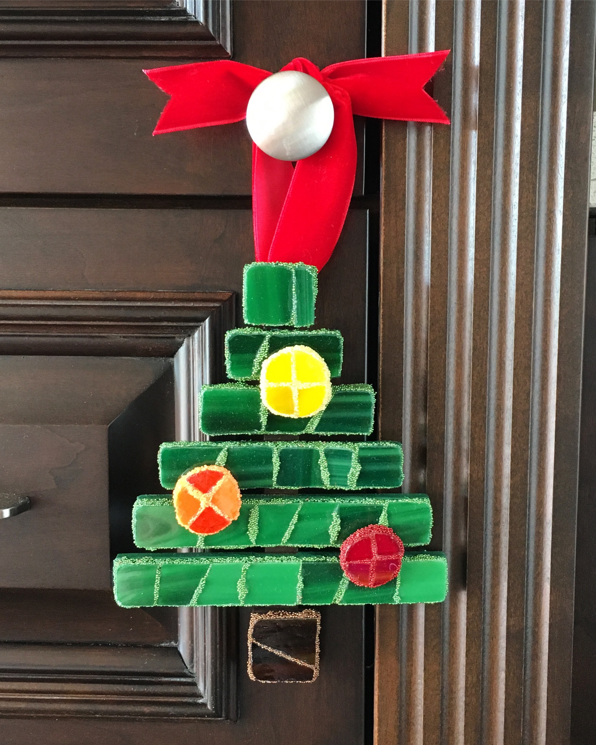 Sharing a handmade modern mosaic Christmas tree ornament covered in stained glass with a special grout of micro beads. The ornament hangs from a red velvet ribbon.🎄

For mosaic tips, tutorials, inspiration, and so much more please visit my YouTube channel: YouTube.com/julieweilbacher. 

I like to display ornaments on knobs and door handles around the house.

Follow @julieweilbacher on Instagram for all things mosaic art. glass mosaic - stained glass - Christmas mosaic - glass ornaments - modern Christmas tree - hostess gift - teacher gift - fancy ornament - handmade ornament

#LTKhome #LTKSeasonal #LTKHoliday