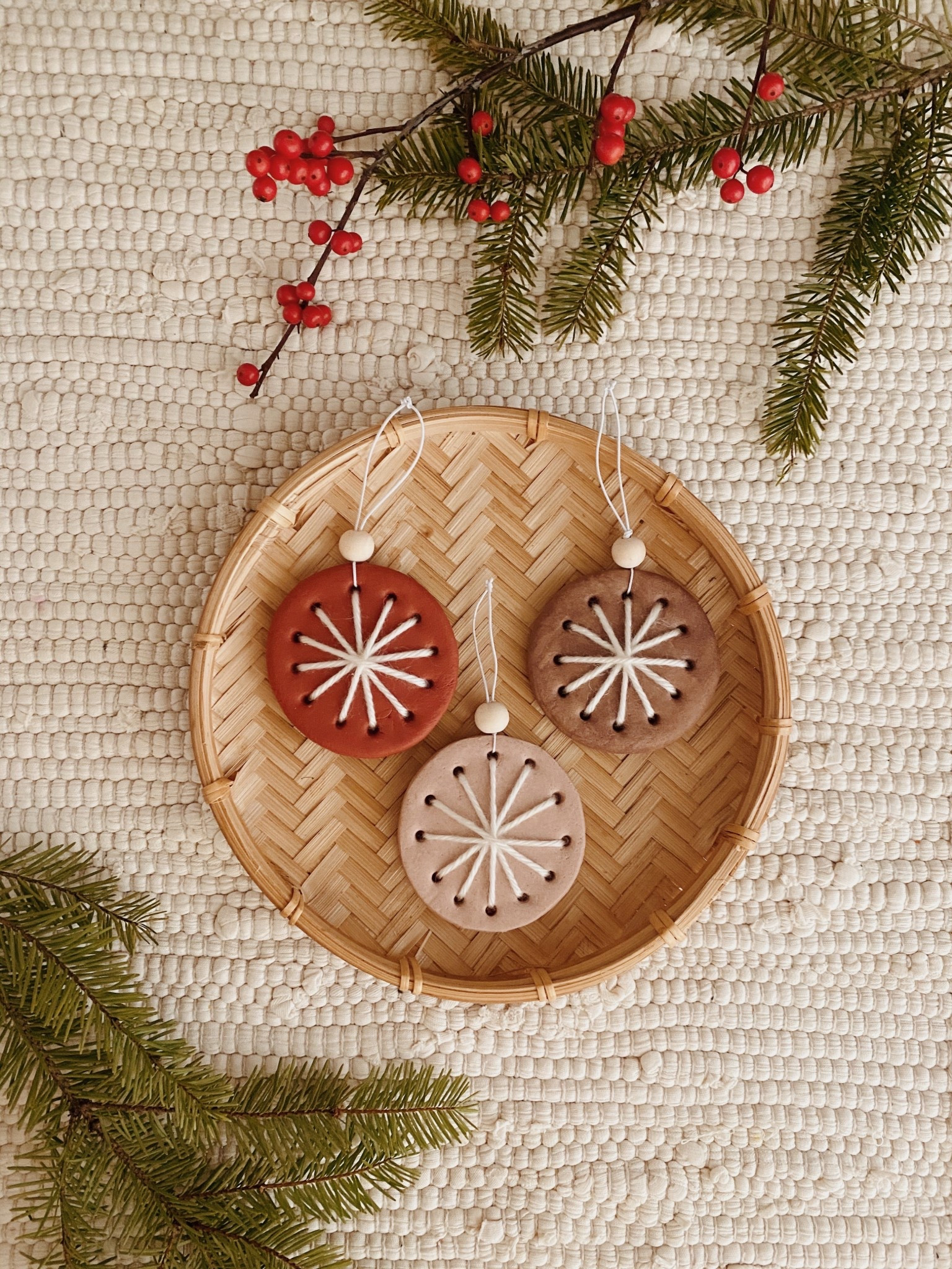 SUCH a simple way to make sweet snowflake ornaments — 

make balls out of your oven bake (or air dry) clay and roll out. poke large holes all around the diameter of your circle and then bake.

use a thick needle and embroidery floss to go across each direction overlapping. 

add a string to hang (i added a little wood bead for some flair)

#LTKHoliday
