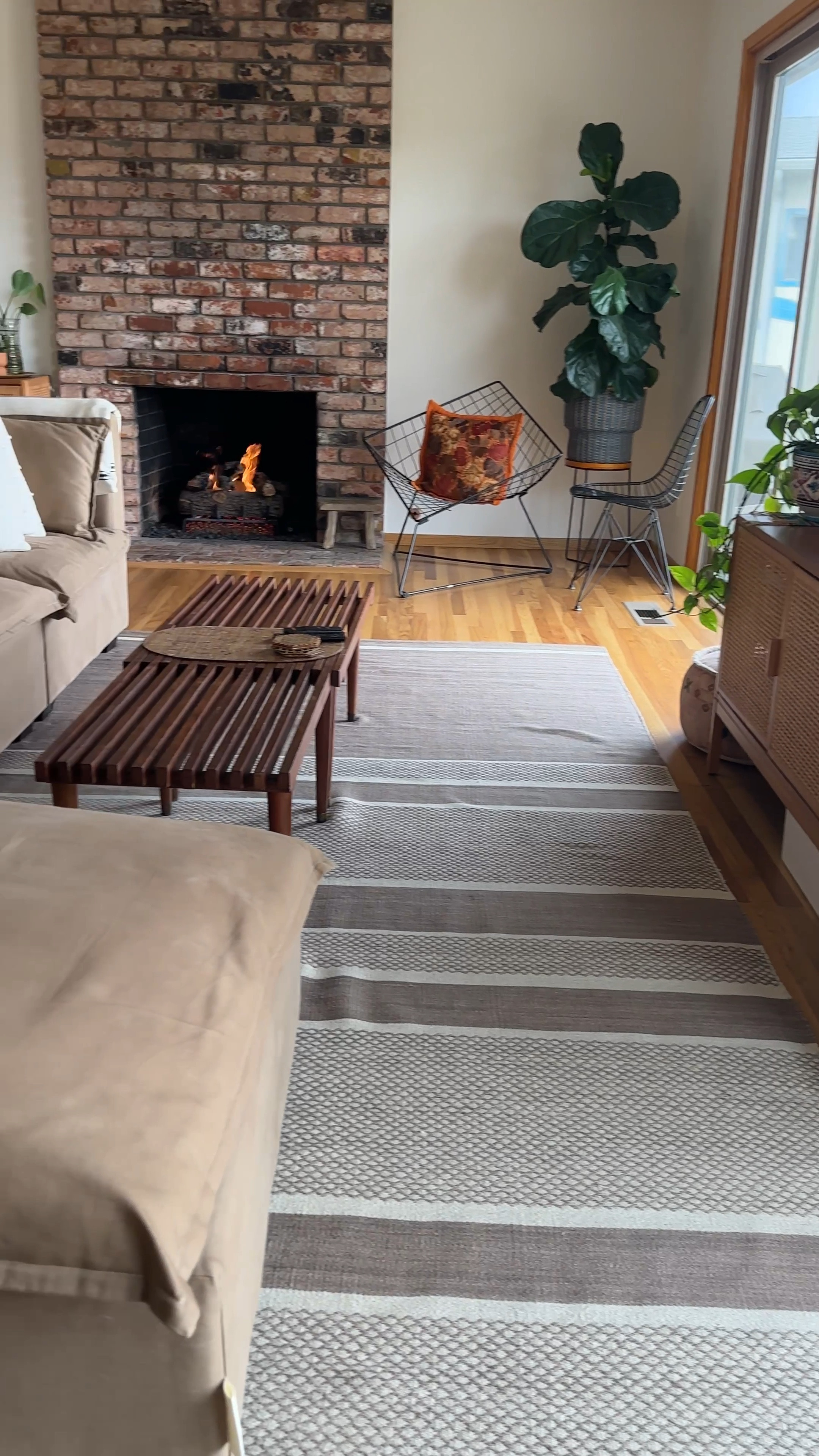 Our Sky House living room is a warm, cozy space with lots of texture and natural materials in a variety of earth tones. Pops of pattern, plants and modernist touches ground our midcentury home and keep it feeling open and inviting // sofa, futon shop modular couch, vintage slat bench coffee table, Eames wire chair, brown wool rug, Samsung the frame tv, caned console, white cotton throw pillows, cotton Turkish blanket, vintage baskets, plant stands 

#LTKhome