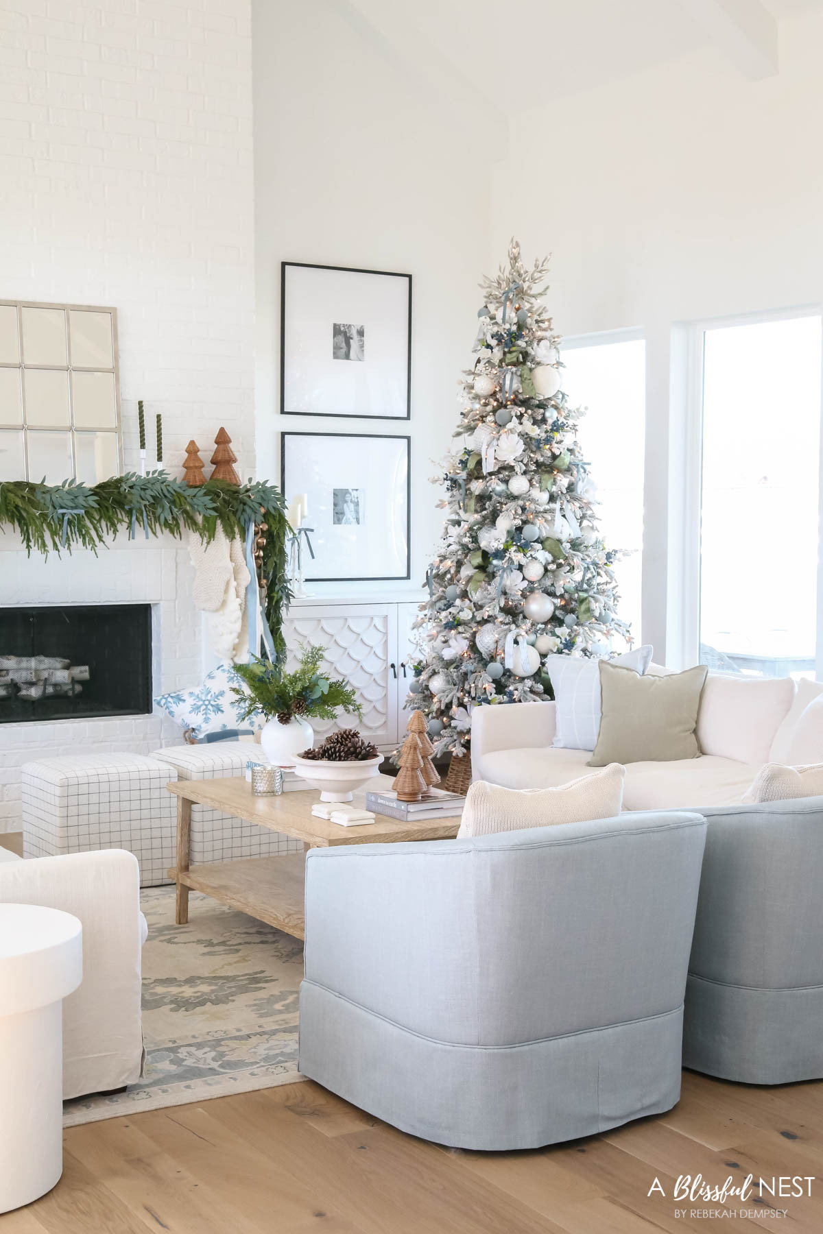 One of my favorite Christmas spaces filled with warmth, greenery, and timeless details. Grab the decor here.
knit Christmas stockings, Norfolk pine Christmas garland, dusty blue satin ribbon, ivory velvet ribbon, vintage cluster cow bells on rope, upholstered cube ottoman, fairy lights, blue berry greenery picks, cream textured throw pillow, baby blue matte Christmas ornaments, velvet Christmas balls, moss green velvet ribbon, dusty blue 2 inch wide satin ribbon, Natural Pine Cones, scented candles, cream sofa, blue shivel chair, green throw pillow, cream throw pillow, snowflakes throw pillow 

 #LTKHoliday #LTKSeasonal #LTKHome