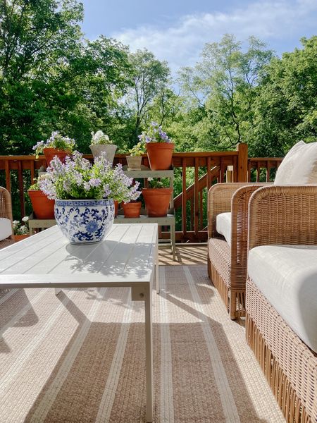 Outdoor deck furniture - budget friendly outdoor coffee table - striped outdoor rug - rattan outdoor furniture - blue and white garden planter 

#LTKSeasonal #LTKover40 #LTKhome