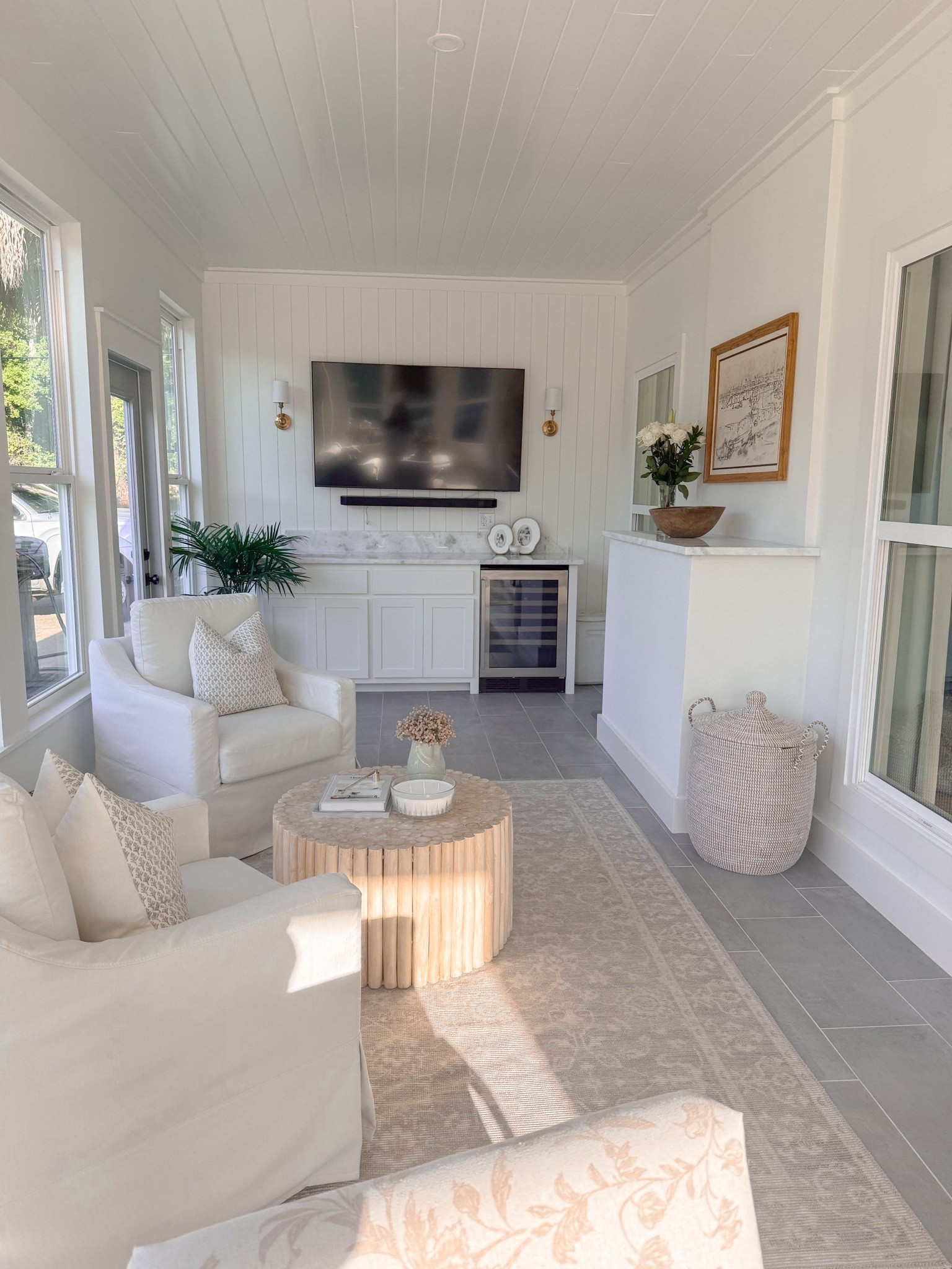 Sunroom. Slipcovered chair. Serena and lily basket. Coffee table. Area rug.

#LTKHome