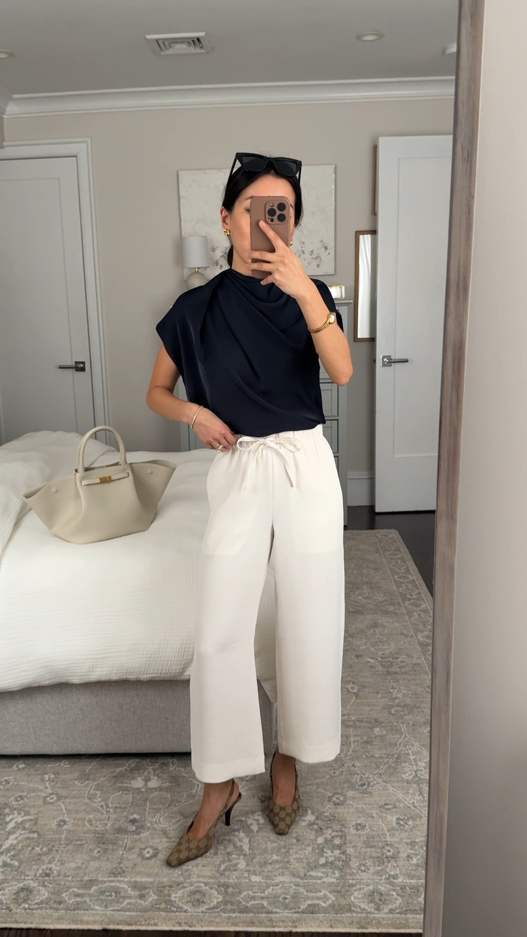 Aritzia lodge pants now come in a new cropped length!

• Lodge pant cropped 2XS, falls a little bit above my ankle, chic flowy look, fully pull on with tie waist

FYI pockets on white show through for me 

• Nominee navy satin blouse 2XS, timeless blouse with elegant asymmetrical drape. Roomier fit with lightweight fabric that drapes and tucks in fluidly.

• Gucci kitten heels

• DeMellier bag

• BP sunglasses

Petite friendly cropped pants, workwear ideas , corporate style 

#LTKPetite #LTKWorkwear #LTKootd