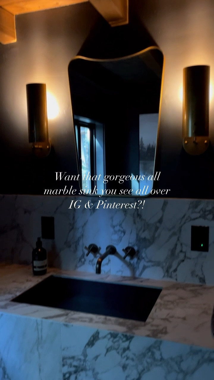 It is possible to achieve the same look for less- and it be just as beautiful and elegant as the one that will cost you double, if not triple!!

HERE IS HOW:

This sink was built with standard 2x4’s- hardy backer then TILED with a large format marble look porcelain tile! We hand selected the tile to have a real marble look but also has a texture to it so when you touched it- it had that organic feel to it to add to the natural stone vibe we wanted to achieve. 

We were quoted over $5k for this vanity in an all marble/dolomite material. We of course said “thanks but no thanks”and asked our tile contractor if he was up for making the vanity for us out of tile! 

We were able to accomplish the same look for 1/2 the cost- we paired it with an awesome matte black ramp sink- antique brass wall mount faucet and a luxury mirror and backlit sconces to create an over all moody, luxurious and organic powder room!

Save this video for your next DIY project or home remodel inspiration! 🤍✨

-
#TheLakeArrowheadTreeHouse #KraftedCollection 
-
Lead Designer @karrinarotter of @thekraftedhome 
-
#moodybathroom #powderroomdesign #bathroom #bathroomdesign #bathroomdecor #bathroominspiration #bathroomremodel #diy #diyhomeprojects #diybathroom #marblesink #marbleslab #marble #bathroomrenovation #homedesign #homedesignideas #interiordesign #uniquehomes #cabinporn #cabinhome #lakehousedecor #lakehouse #housevibes #moodyhome #diyvanity #tiledvanity #tiledesign #tilesink 

#LTKhome #LTKstyletip #LTKVideo