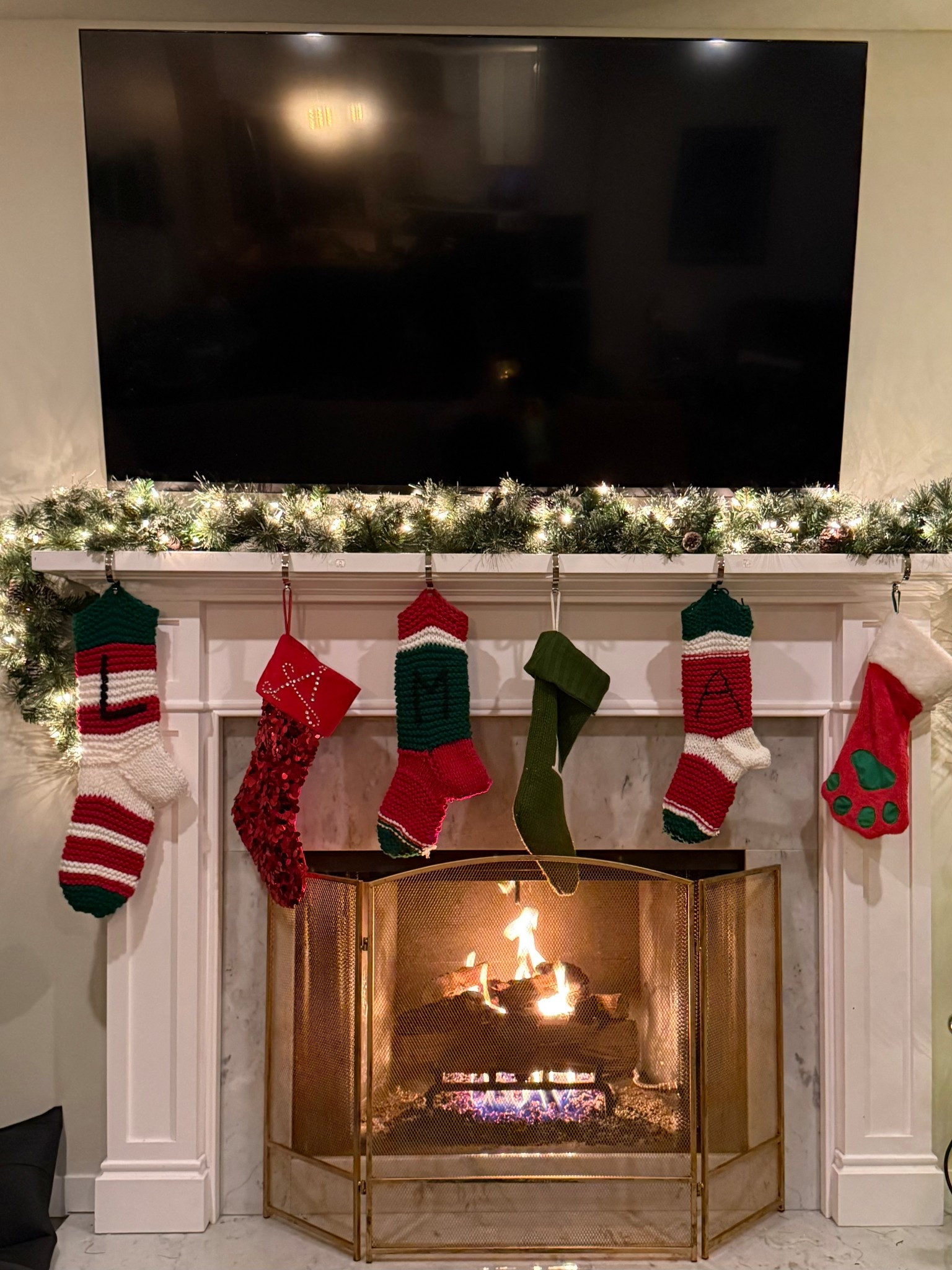 A cozy Christmas fireplace setup! Check out these festive stocking holders and a warm, glowing fireplace screen. 🎄🔥

#LTKSeasonal #LTKHoliday #LTKHome