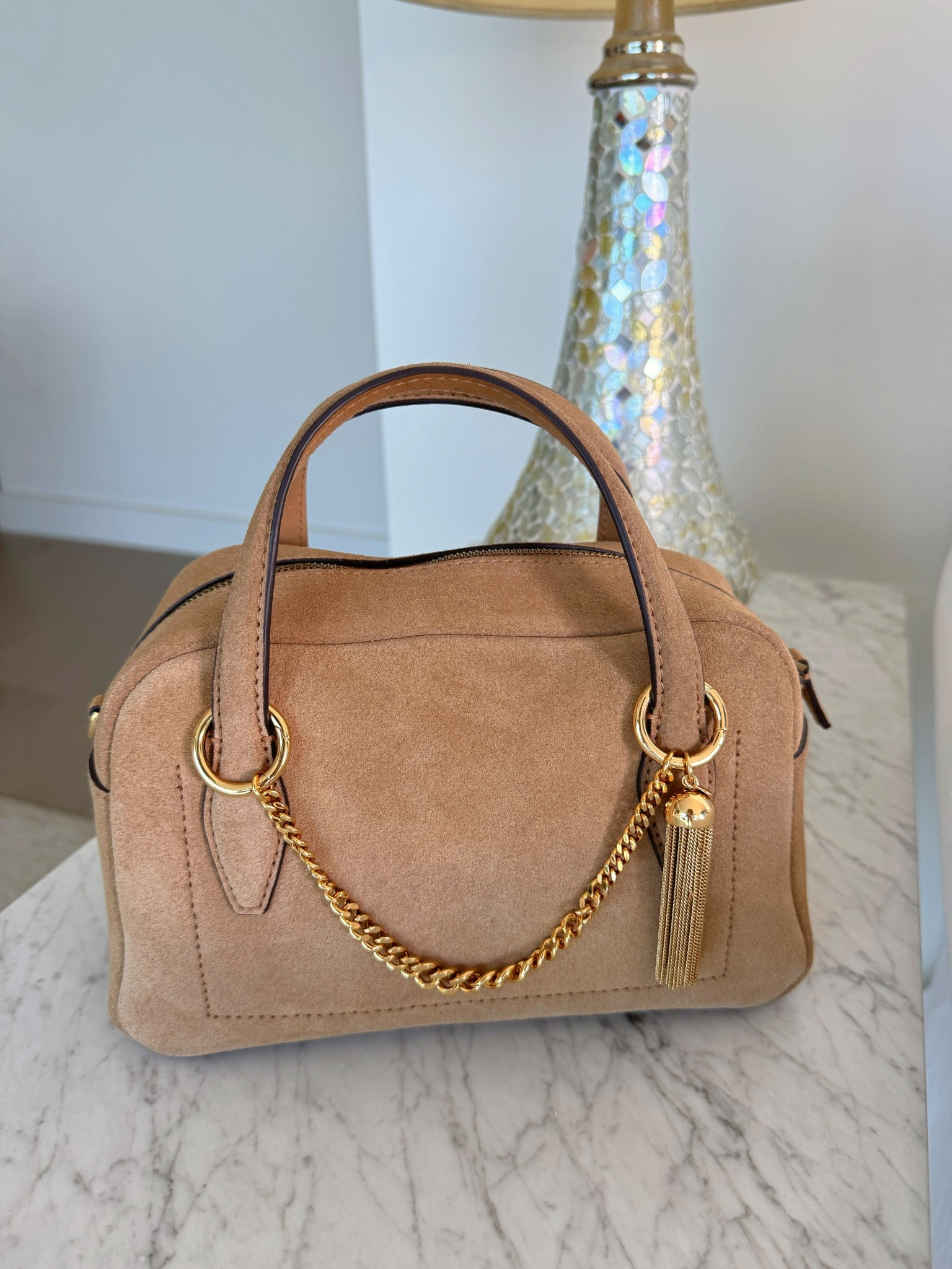 This is a really great suede bag that seems to go with everything! but even better is this little gold tassel chain which I can add to any bag to make it more chic! 

#LTKItBag #LTKStyleTip #LTKxMadewell
