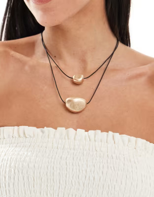 ASOS DESIGN multirow necklace with cord and brushed charms in gold tone | ASOS (Global)