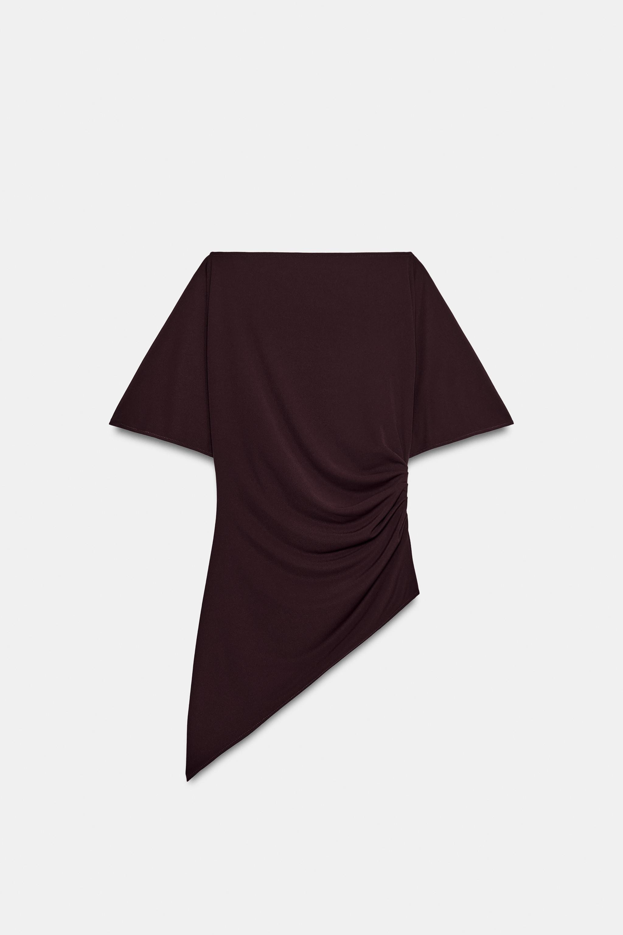 Top made of flowy fabric. Boat neck and short sleeves. Side draping detail. Asymmetric hem. | Zara US