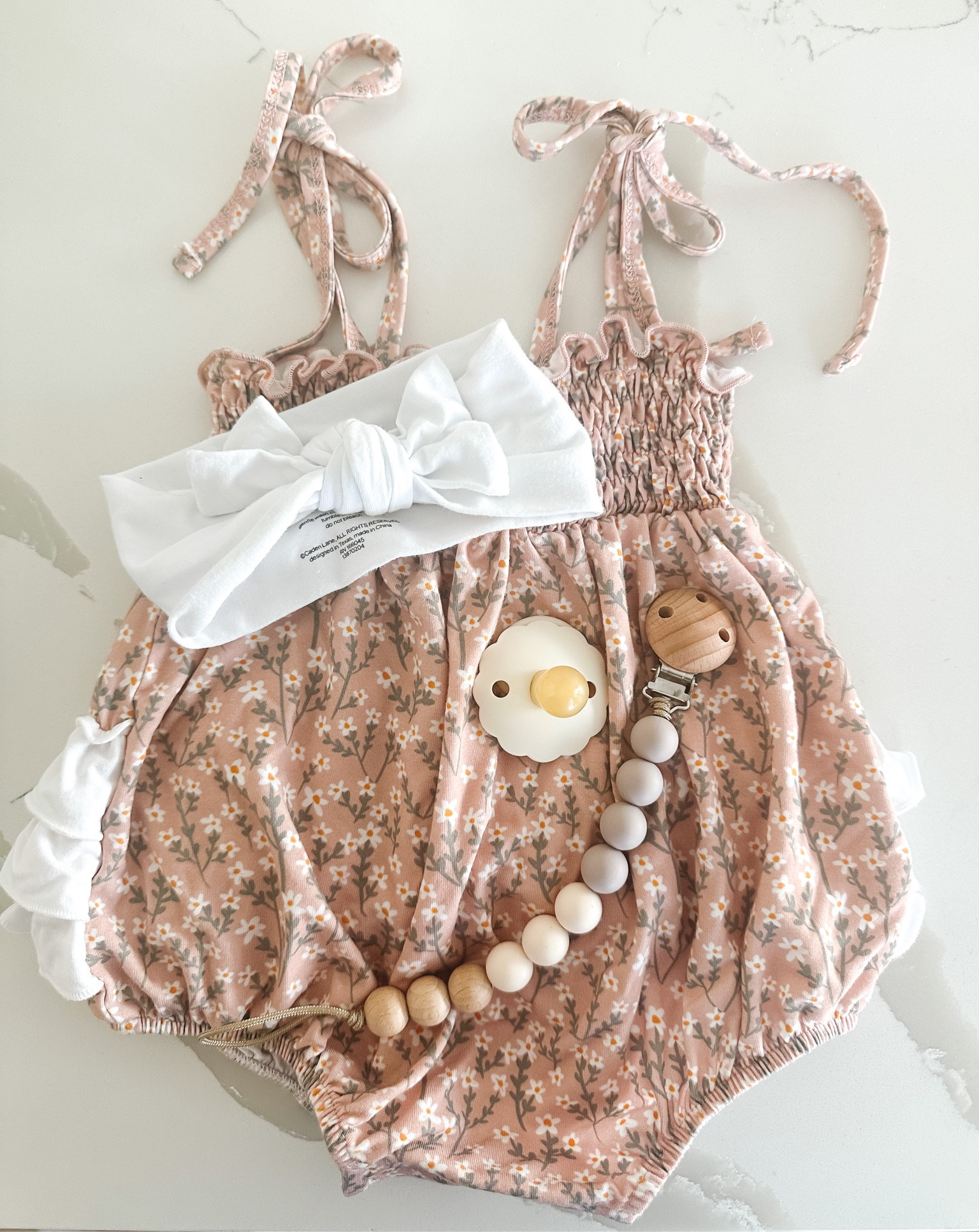 Floral ruffle bubble romper paired with white bow! Love the bow tie straps, floral pattern, ruffle on the bottom and that it’s stretchy! 

#LTKbaby #LTKstyletip