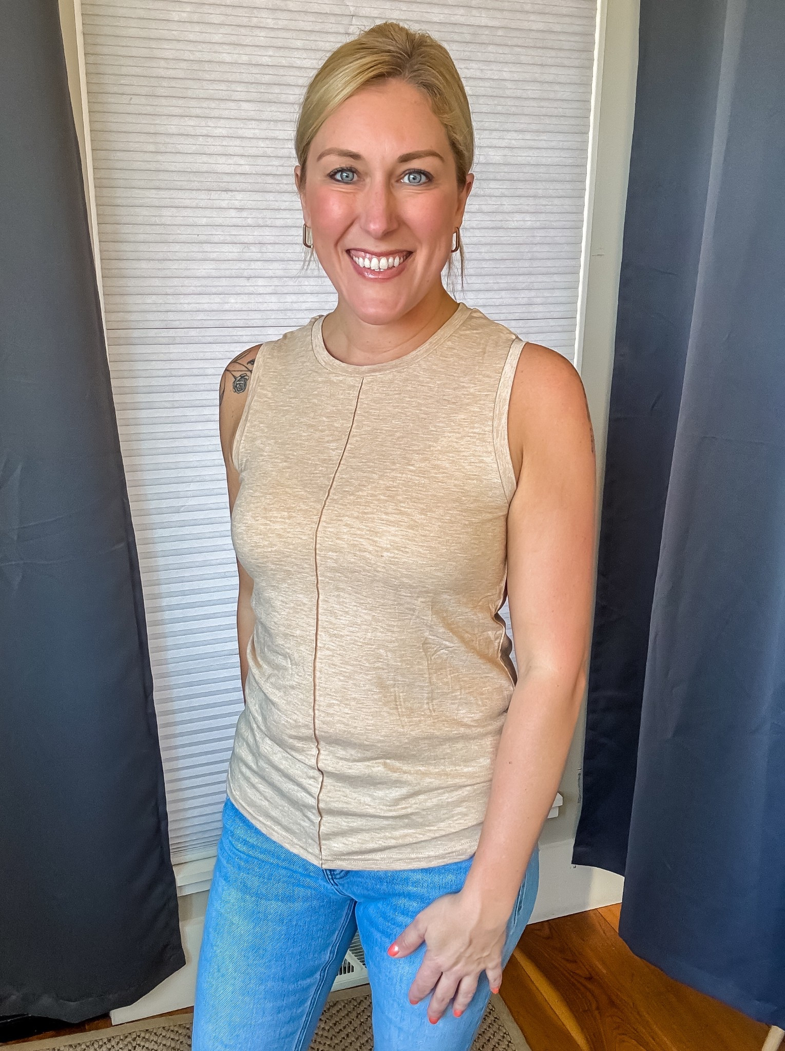 This sleeveless top is sooooo comfortable! I love exposed seam detail on the front for an added touch. Super soft fabric and a great fit. Comes in a bunch of great colors too!