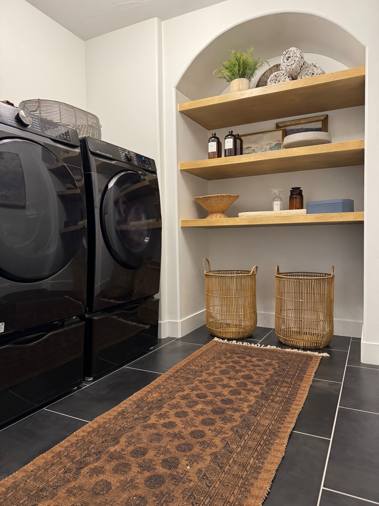 Laundry room inspo with arched shelving! These glass amber bottles are my favorite for keeping fabric softener and sanitizer in! And I keep my dryer sheets in the shagreen box! 

#LTKHome #LTKFindsUnder100 #LTKFindsUnder50