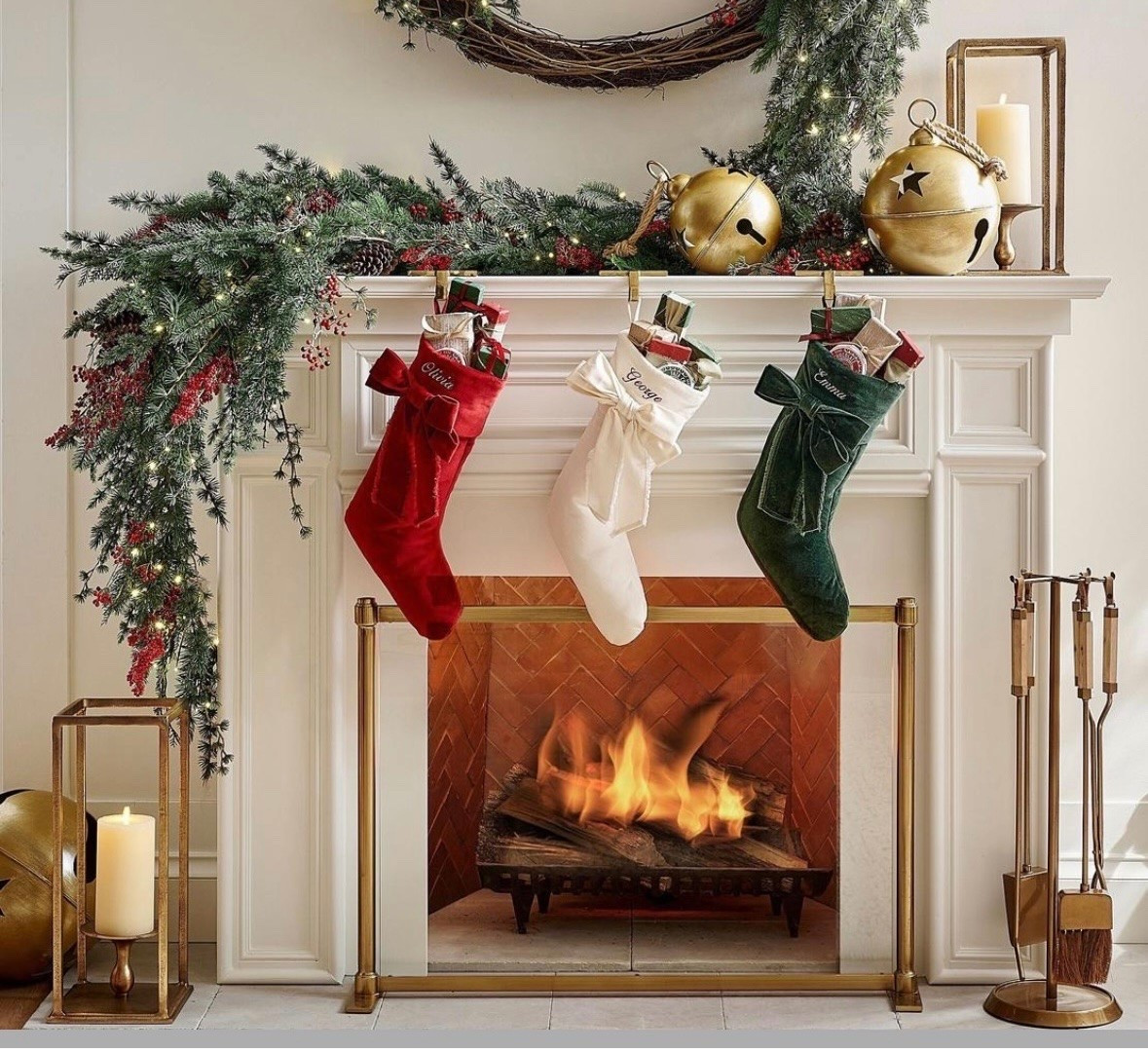 Holiday mantle styling with Christmas stockings, ships free, wreaths, garland, hurricane candleholders, fireplace accessories, Christmas decor.

#LTKHome #LTKSeasonal