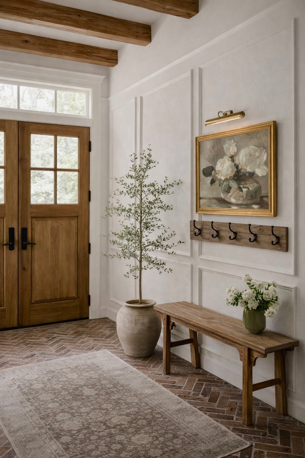 It’s easy to decorate an entryway if you think of these simple rules:

Make it feel natural. This bench and coat rack is natural for an entryway where you would drop your shoes and coat. They can be decorative and beautiful and functional at the same time. Next make a focal point that’s what the art does here. Finally add some height and life stems and trees are a great way to do this. 

#LTKHome #LTKstorytime #LTKSeasonal