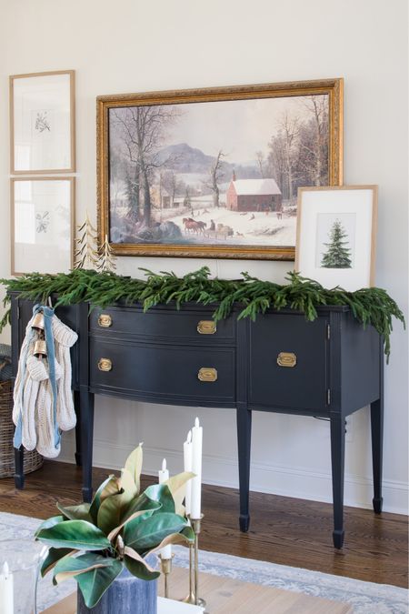 Vintage buffet holds our Christmas stockings with brass bells, velvet ribbon and the art on our frame tv adds to the decor

#LTKSeasonal #LTKHoliday #LTKhome