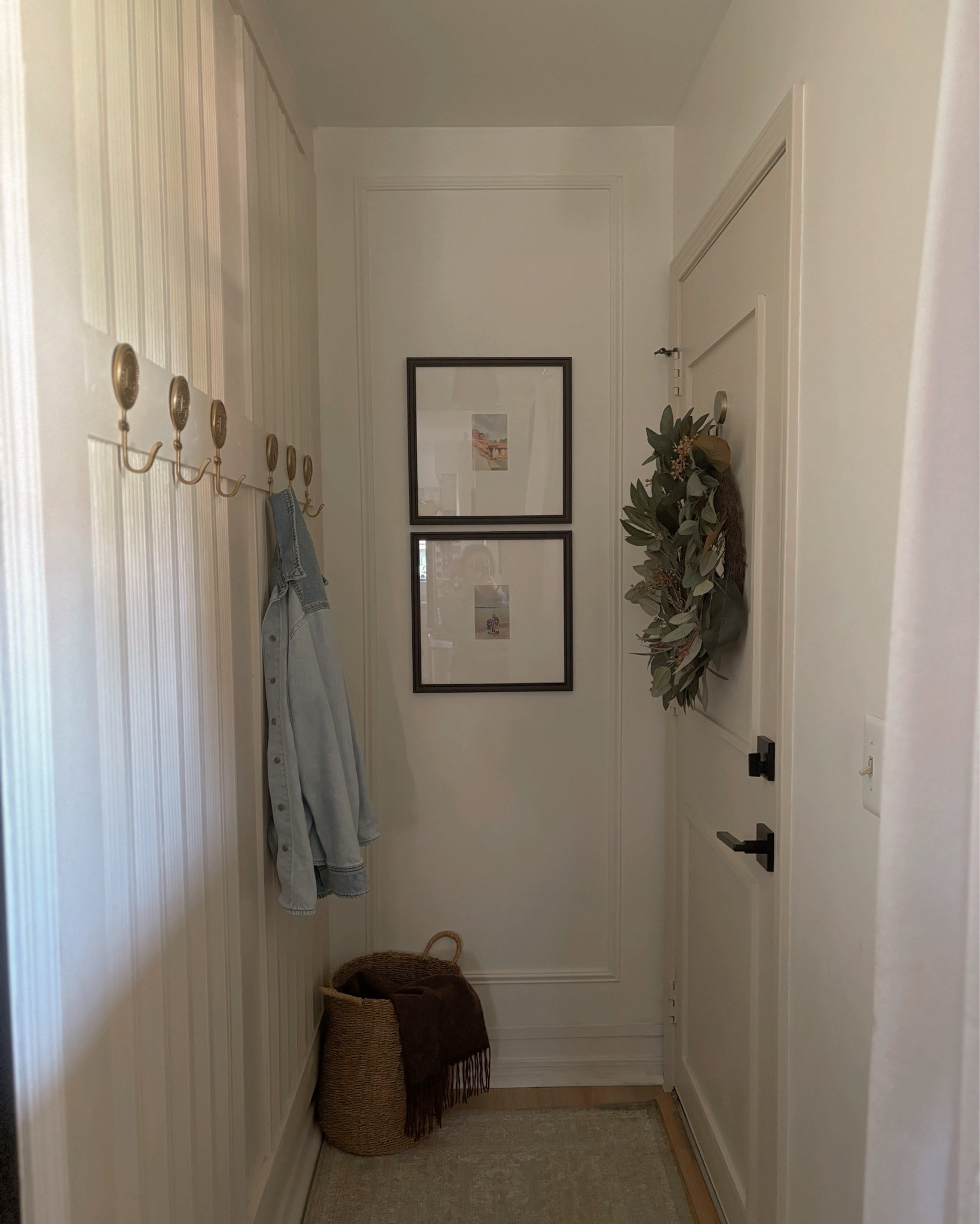 Tight entryway spaces can still be pretty AND functional!
Our garage entry space in our 1980s home is narrow and tight. So, I wanted to keep everything minimal yet practical. These Anthropologie hooks are sturdy and beautiful and used to hang coats and jackets. Hats and gloves, etc. can be thrown into the basket. I added some wall trim and fluting to elevate the space without “taking space” while still maintaining visual interest. Added these beautiful black frames from Target to personalize this space. What do you think? 

#LTKHome