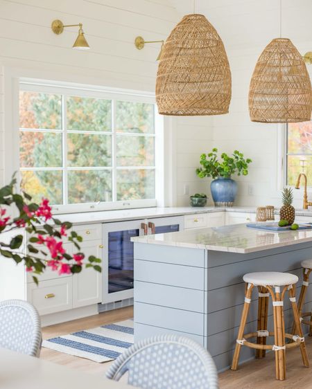 *Many of these items are currently on sale* We loved our large size basket pendant lights in our Omaha pool house kitchen! Our white backless counter stools, striped blue runner rug, blue ceramic vase, gold star sconce lights and other kitchen favorites complete the look .

#ltkhome #ltksalealert #ltkfindsunder100 #ltkfindsunder50 #ltkstyletip #ltkseasonal 

#LTKSeasonal #LTKsalealert #LTKhome